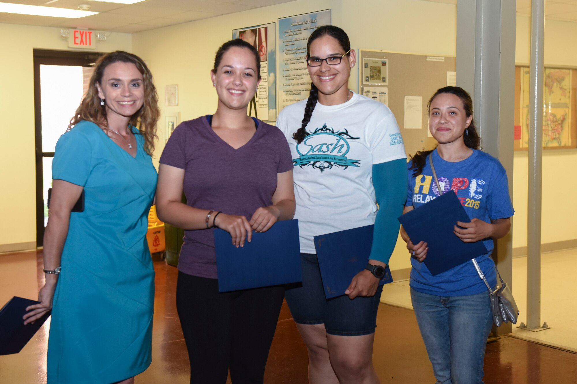 Donna L. Casey, 17th Training Wing Sexual Assault and Response Coordinator, presents certificates of appreciation to three technical training Airmen for being outstanding Teal Ropes at the Crossroads Student Center on Goodfellow Air Force Base, Texas, April 26, 2016. The Teal Rope program helps educate Airmen about sexual assault and how to report incidents. (U.S. Air Force photo by Airman Chase Sousa/Released)