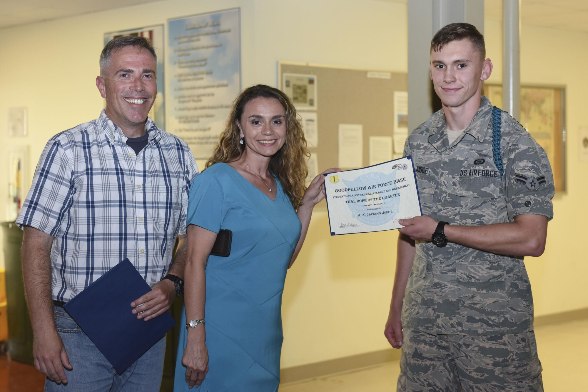 Donna L. Casey, 17th Training Wing Sexual Assault and Response Coordinator, presents the Teal Rope of the Quarter award to Airman 1st Class Jackson A. Judge, 315th Training Squadron student, at the Crossroads Student Center on Goodfellow Air Force Base, Texas, April 26, 2016. The Teal Rope program is implemented in all technical training environments to raise awareness of sexual assault. (U.S. Air Force photo by Airman Chase Sousa/Released)