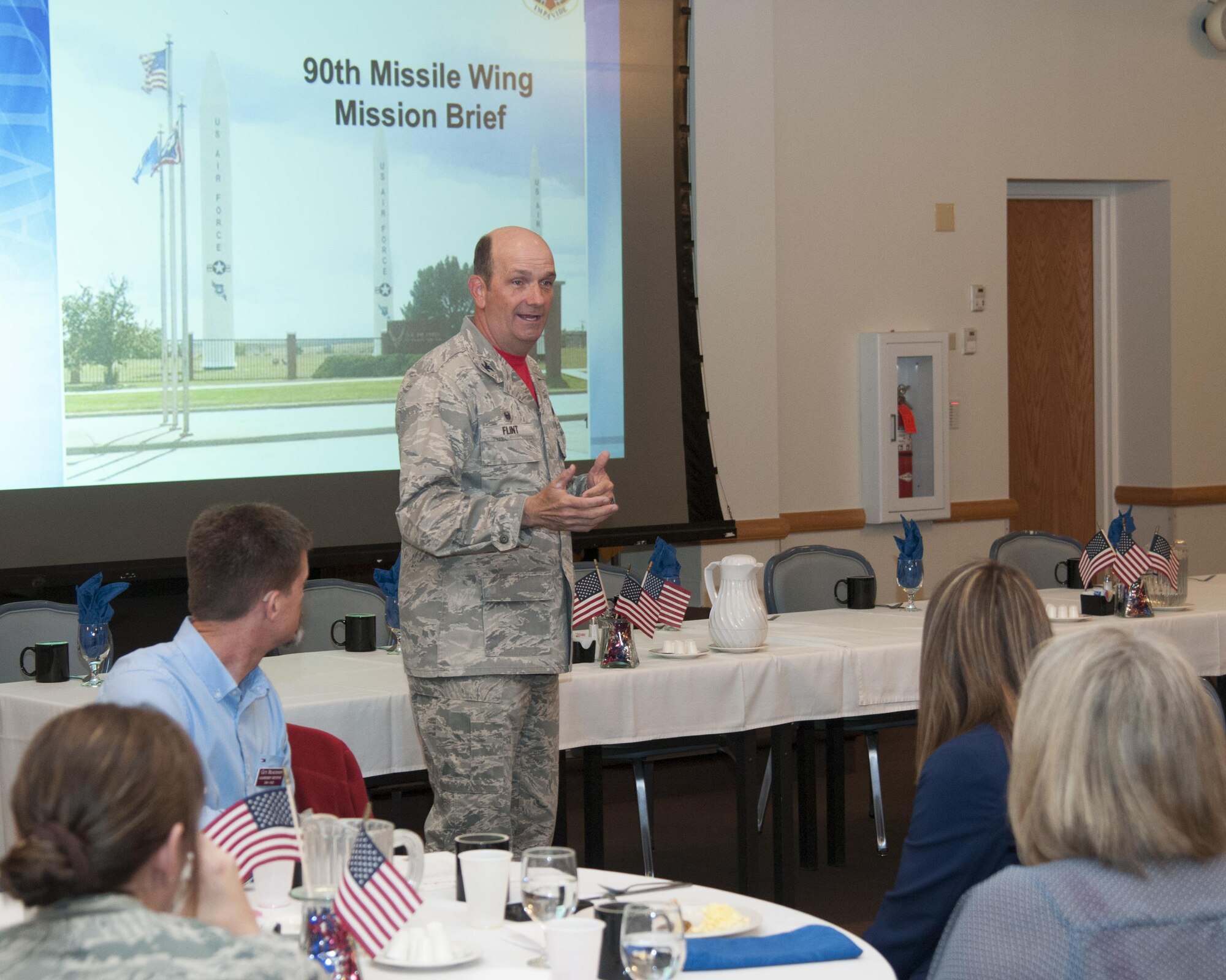 Colonel Trevor Flint, 90th Maintenance Group commander, gives the 90th Missile Wing Mission Brief to a Leadership Cheyenne class as they began their tour of F.E. Warren Air Force Base, Wyo., April 22, 2016. The mission brief details the mission and organization of the wing. (U.S. Air Force photo by Senior Airman Jason Wiese)