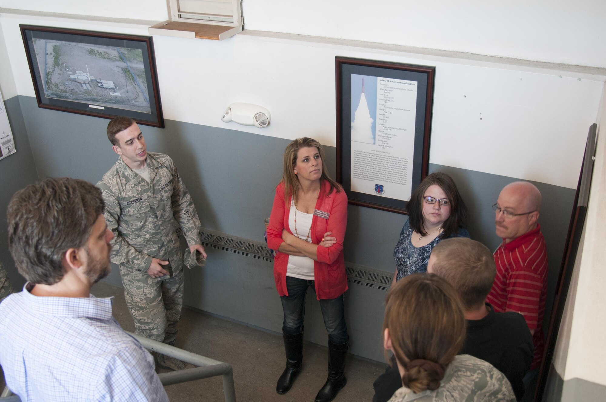 Staff Sgt. Ryan Ackerman, 790th Maintenance Squadron trainer maintainer, explains maintenance diagrams as he leads  atour group from Leadership Cheyenne downstairs to the lower level of the U-01 training facility on F.E. Warren Air Force Base, Wyo., April 22, 2016. U-01 is a mock launch facility that Airmen use for maintenance training. (U.S. Air Force photo by Senior Airman Jason Wiese)