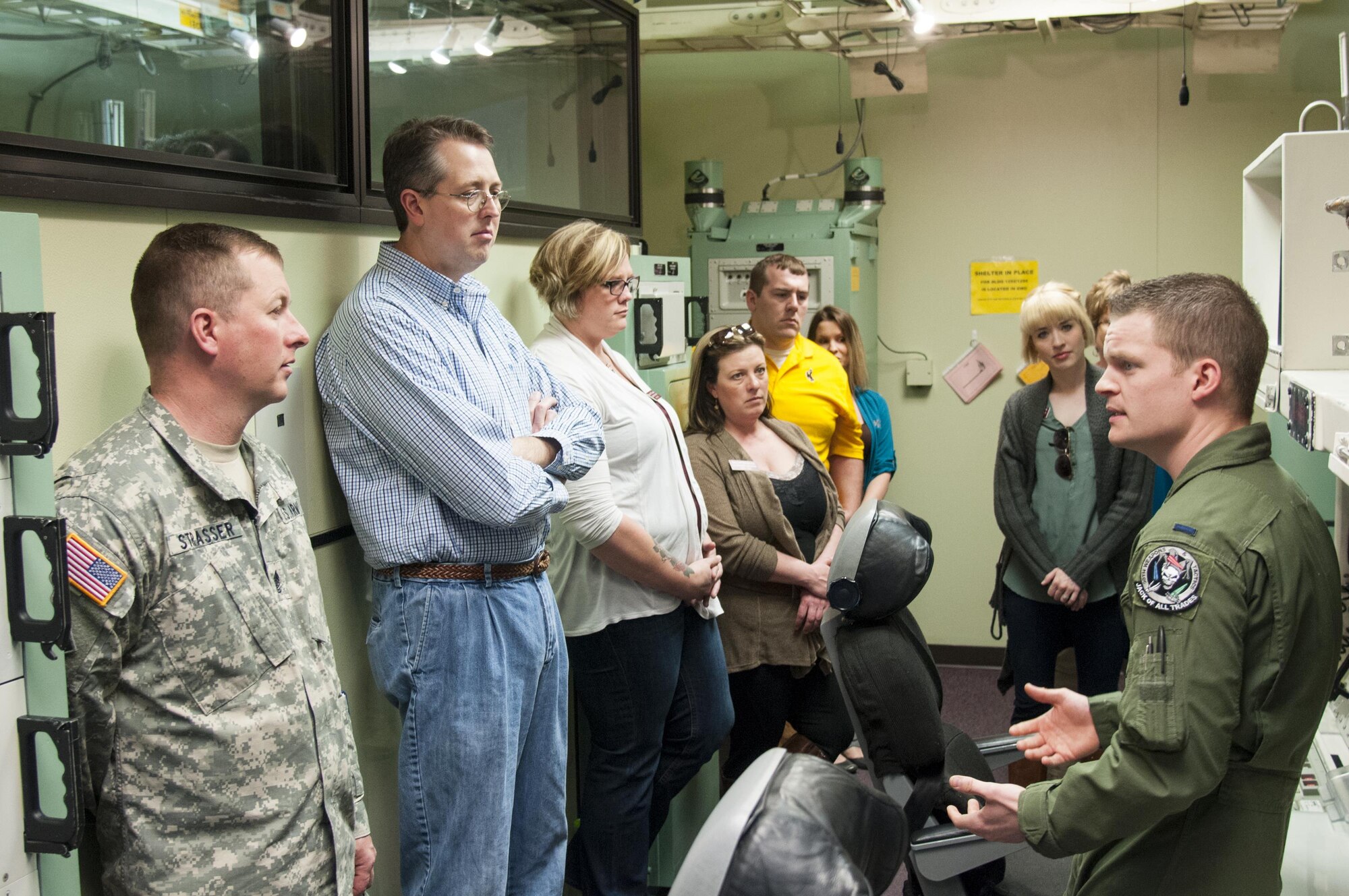 First Lt. Jeffrey Mattheis, 90th Operations Support Squadron missile combat crew instructor, talks to a Leadership Cheyenne class group about the 90th OSS Missile Procedures Trainer and missile operations April 22, 2016, in the MPT on F.E. Warren Air Force Base, Wyo. The MPT is a mock launch control center, which missileers use to maintain qualifications to perform missile duties. (U.S. Air Force photo by Senior Airman Jason Wiese)