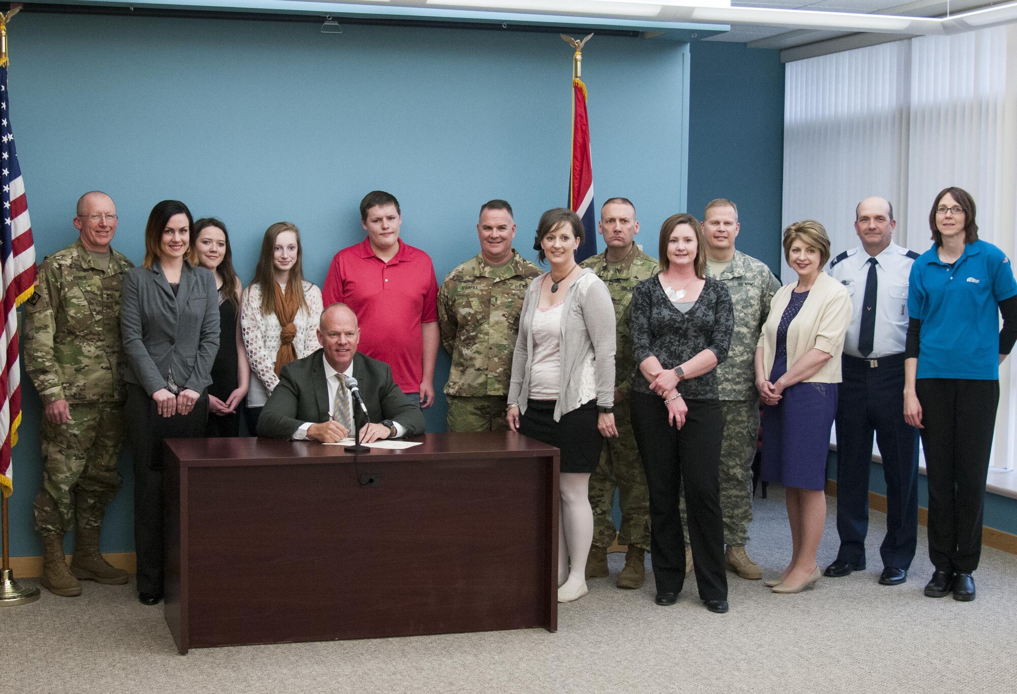 Wyoming Gov. Matt Mead and distinguished guests pose for a photo after Mead signed a proclamation declaring the month of April as Month of the Military Child April 25, 2016, in the Wyoming State Museum in Cheyenne. Representatives and families from military organizations throughout the state attended the event to show support. (U.S. Air Force photo by Senior Airman Jason Wiese)