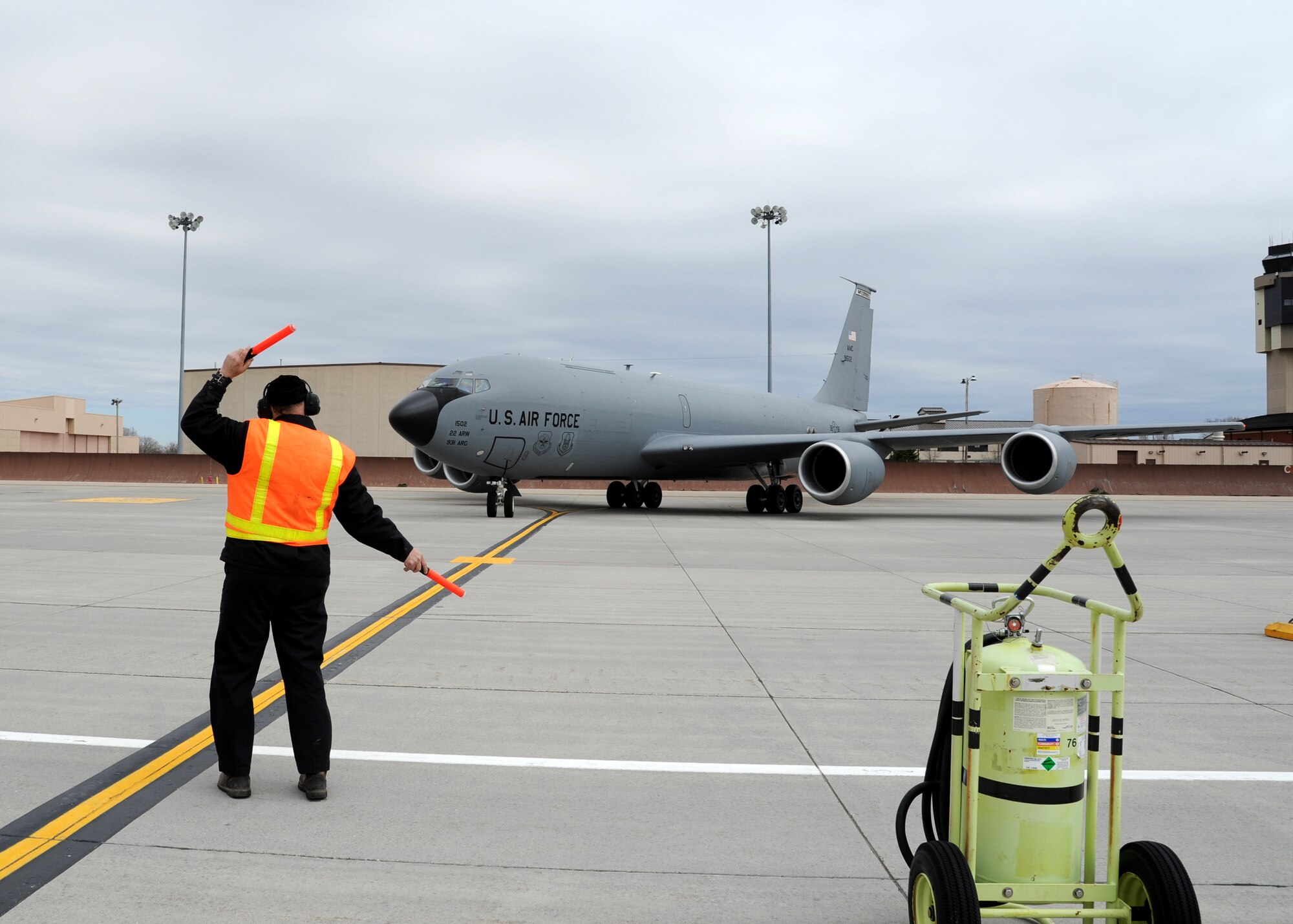 Dale Conner, 319th Operations Support Squadron aircraft server, directs a KC-135 Stratotanker April 26, 2016, on Grand Forks Air Force Base, N.D. The aircraft arrived from McConnell Air Force Base, Kan., as part of a severe weather evacuation. (U.S. Air Force photo by Airman 1st Class Ryan Sparks/Released)
