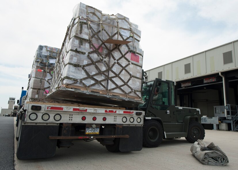Staff Sgt. Damon Huddleston, 436th Aerial Port Squadron traffic management, uses a forklift to load palletized cargo onto a flatbed truck April 26, 2016, at the Aerial Port on Dover Air Force Base, Del. This cargo will be transported to Joint Base McGuire-Dix-Lakehurst, N.J., to be loaded onto a contracted 747 cargo plane. (U.S. Air Force photo/Senior Airman Zachary Cacicia)