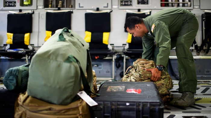 Staff Sgt. Luis Diaz, 15th Airlift Squadron loadmaster, straps down luggage and cargo April 25, 2016, on a C-17 Globemaster III at Joint Base Charleston – Air Base, S.C. The 437th Airlift Wing flew into Manta, Ecuador, in support of earthquake relief operations. Aboard the aircraft were Army personnel from the Contingency Response Group as well as equipment including a mobile control tower and a five-passenger vehicle. The 437th AW provides global reach airlift capability at anytime and anywhere in the world. Whenever natural disasters occur, the 437th AW can provide humanitarian aid in a moment’s notice. (U.S. Air Force photo/Senior Airman Clayton Cupit)