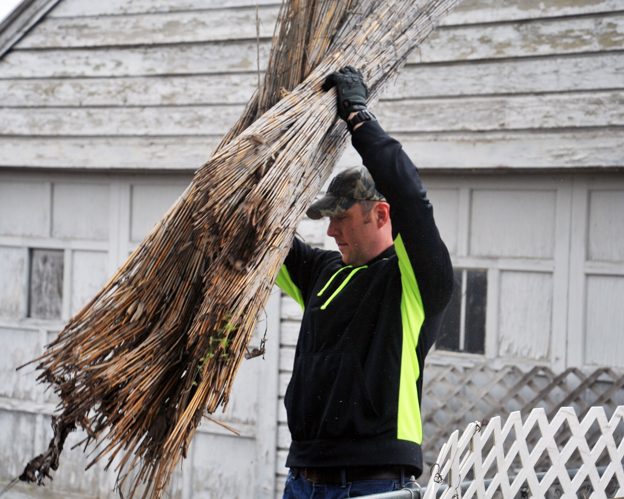 Staff Sgt. Brian Huls, 93rd Air Refueling Squadron boom operator, removes part of an old fence during a volunteer event for a local family April 23, 2016 in Spokane, Wash. Airmen helped remove an old roof and install a new one, dug post holes and mixed cement to lay brand new vinyl fencing, trimmed trees around the home, cleared plants that were overgrown on both sides of the home and leveled and prepared the back yard for sod. (U.S. Air Force photo/Staff Sgt. Samantha Krolikowski)