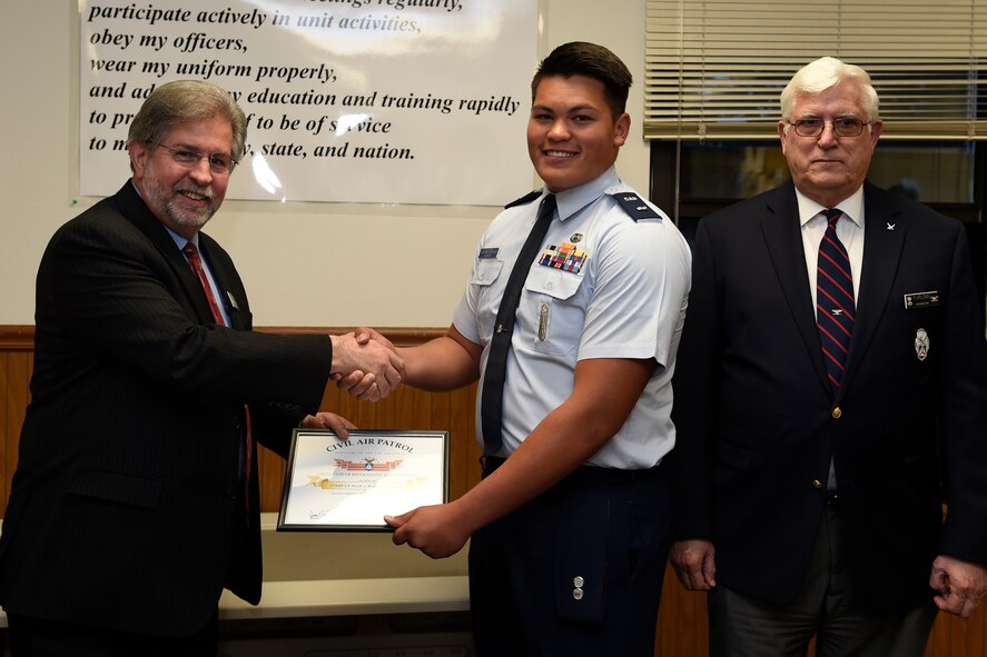 Civil Air Patrol Cadet 1st Lieutenant Max Warren II receives the CAP Certificate of Recognition for Lifesaving from Congressman Steve Kirby (left), Washington’s 29th Congressional District, April 26, 2016 at Joint Base Lewis-McChord, Wash. Warren was able to identify signs of cardiac distress in his father, Donald Warren, provide initial treatment and contacted emergency personnel.  (U.S Air Force photo/Tech. Sgt. Tim Chacon)