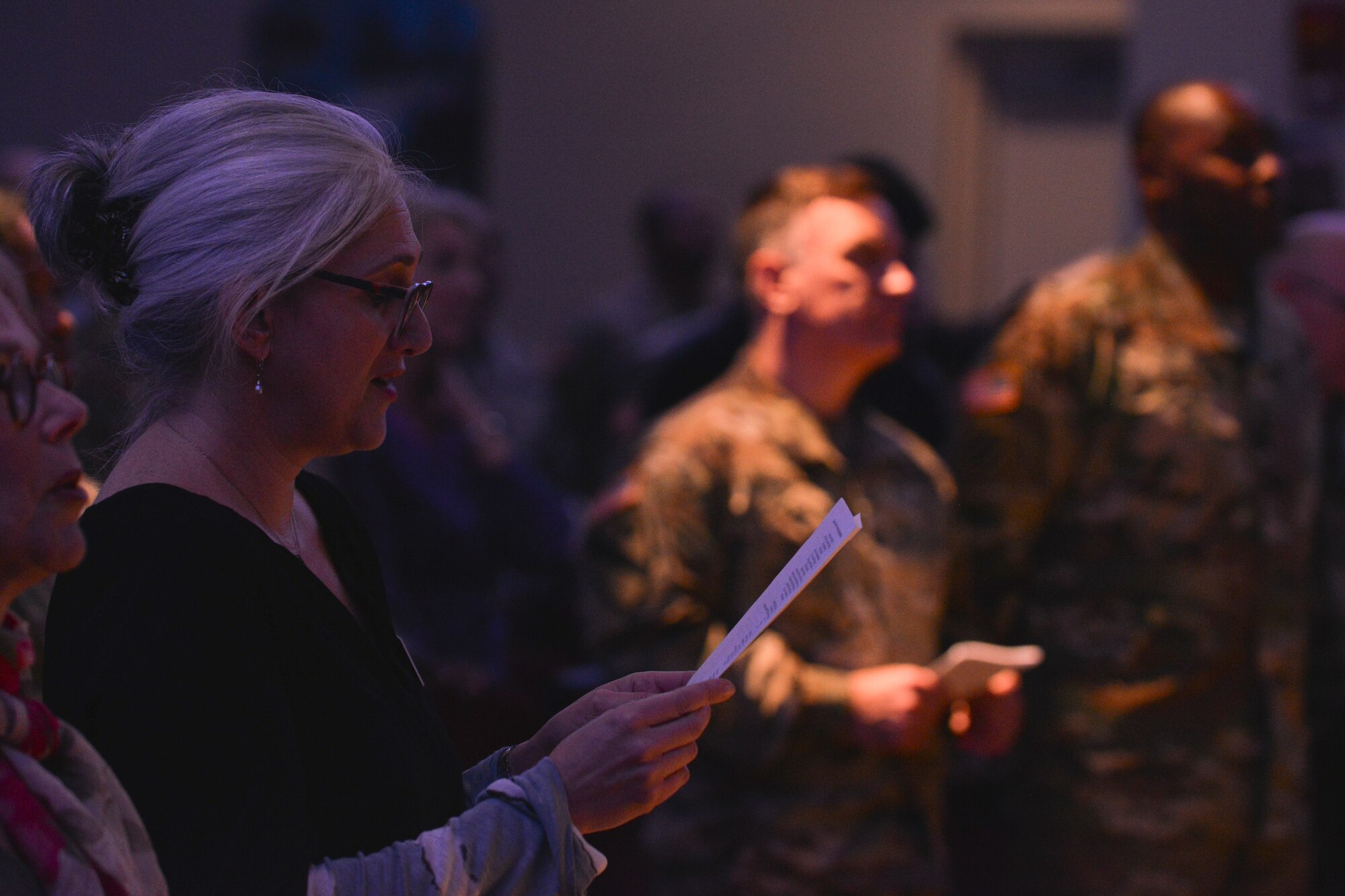 Deb Segaloff, holocaust commission member from the United Jewish Federation of Tidewater, along with other audience members, recites a poem during the Holocaust Days of Remembrance ceremony at Fort Eustis, Va., April 20, 2016. The poem detailed the importance of remembering the holocaust. (U.S. Air Force photo by Staff Sgt. Natasha Stannard)