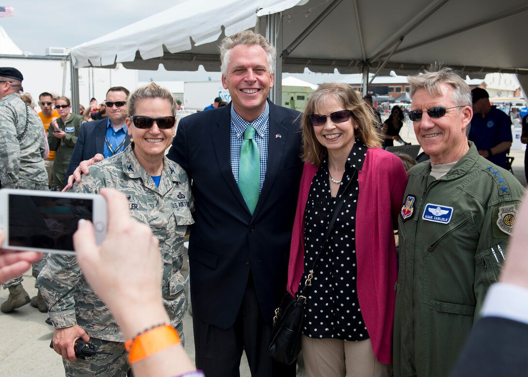 U.S. Air Force Gen. Hawk Carlisle, commander of Air Combat Command and Col. Caroline M. Miller, commander of the 633rd Air Base Wing, pose for a picture with Virginia Governor Terry McAullife at Langley Air Force Base, Va., April 23, 2016. McAullife visited during the AirPower over Hampton Roads Open House, which provides an avenue in which the public can see modern and historical military aircraft in action. (U.S. Air Force photo by Airman 1st Class Derek)