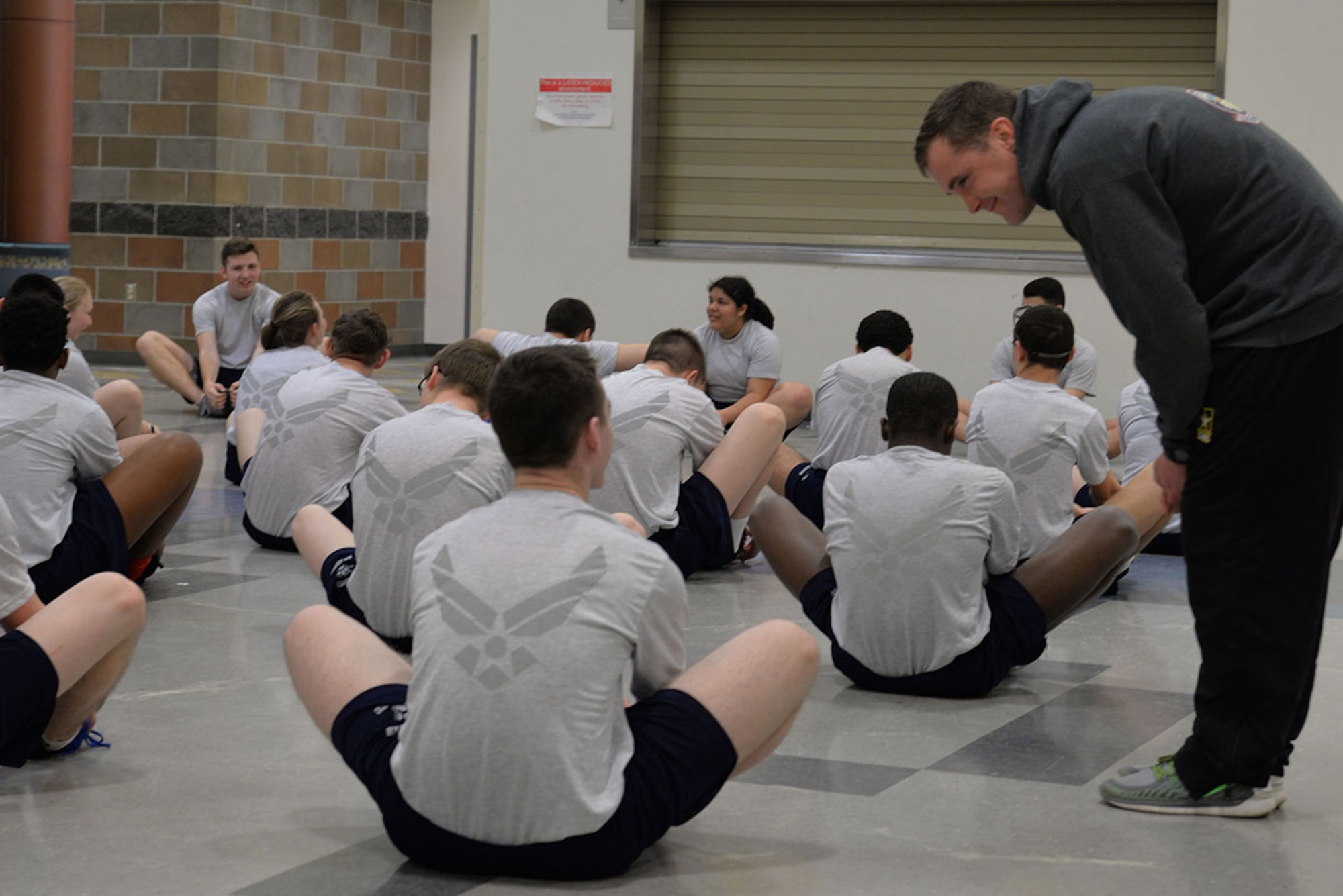 Staff Sgt. Caleb Lloyd, 1st Battalion (Airborne), 501st Infantry Regiment assistant operations officer and noncommissioned officer in charge for the 1-501st IN’s partnership with Eagle River High School in support of the Joint Base Elmendorf-Richardson School Partnership Program, listens to an Eagle River High School Junior ROTC cadet during physical training at the school in Eagle River, Alaska April 1, 2016. Lloyd works with the cadets’ PT program each Friday during the school year. (U.S. Air Force photo by Jamie Topliff)