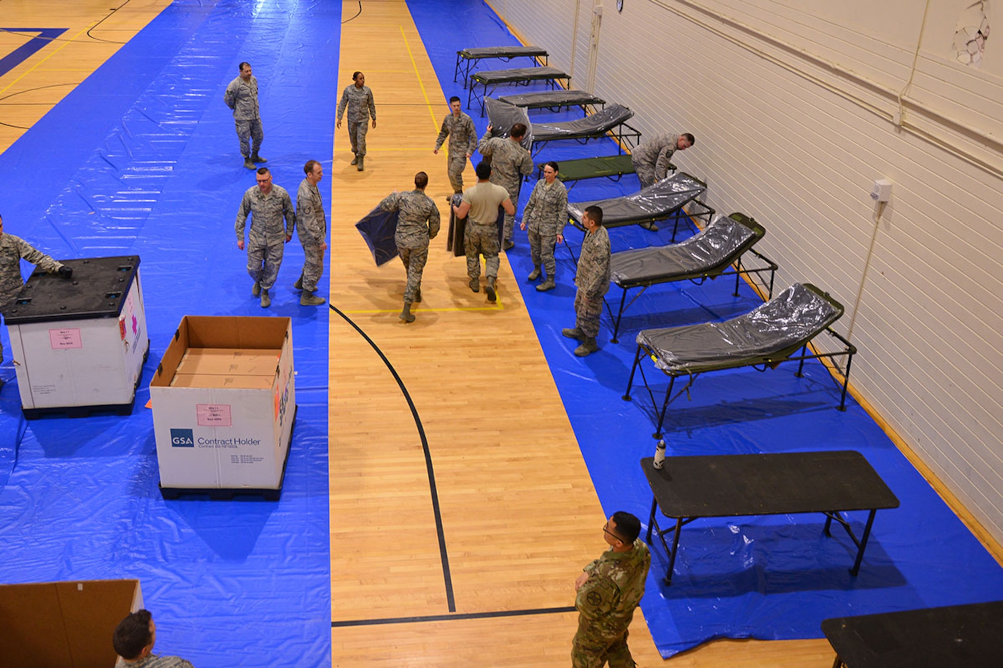 673d Medical Group personnel set up their first localized en-route patient staging system at the Elmendorf Physical Fitness Center April 21. The ERPSS is designed to act as a temporary staging location for patients the hospital does not have room for in the event of a major incident before being flown out of the area. (U.S. Air Force photo by Airman 1st Class Kyle Johnson)