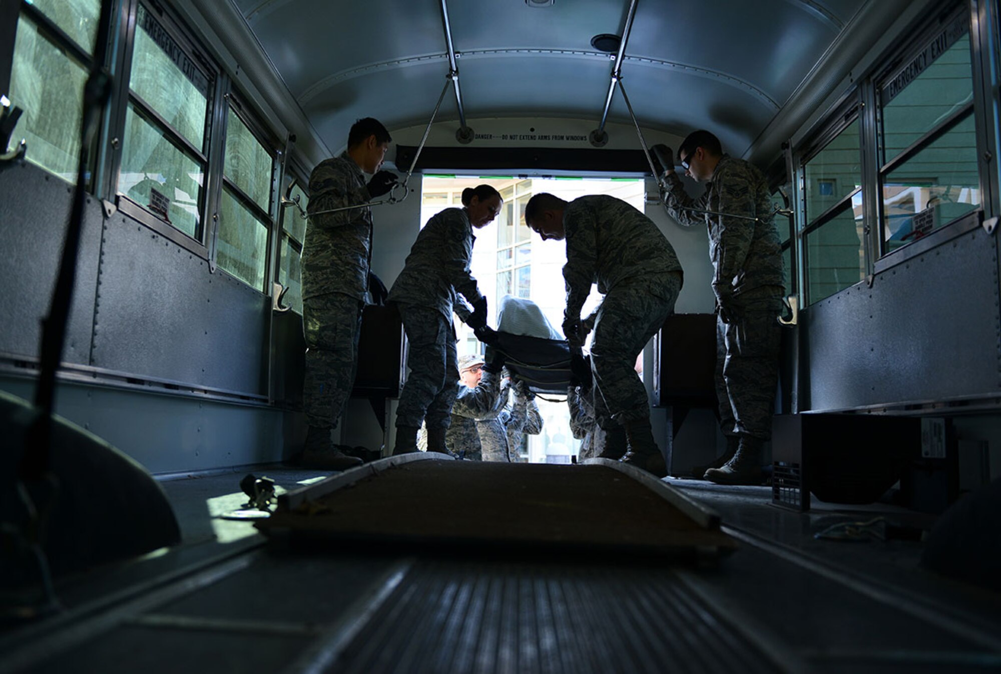 673d Medical Group personnel load patients into a transport bus as part of their first localized en-route patient staging system training at the Elmendorf Physical Fitness Center April 21. The ERPSS is designed to act as a temporary staging location for patients the hospital does not have room for in the event of a major incident before being flown out of the area. (U.S. Air Force photo by Airman 1st Class Kyle Johnson)