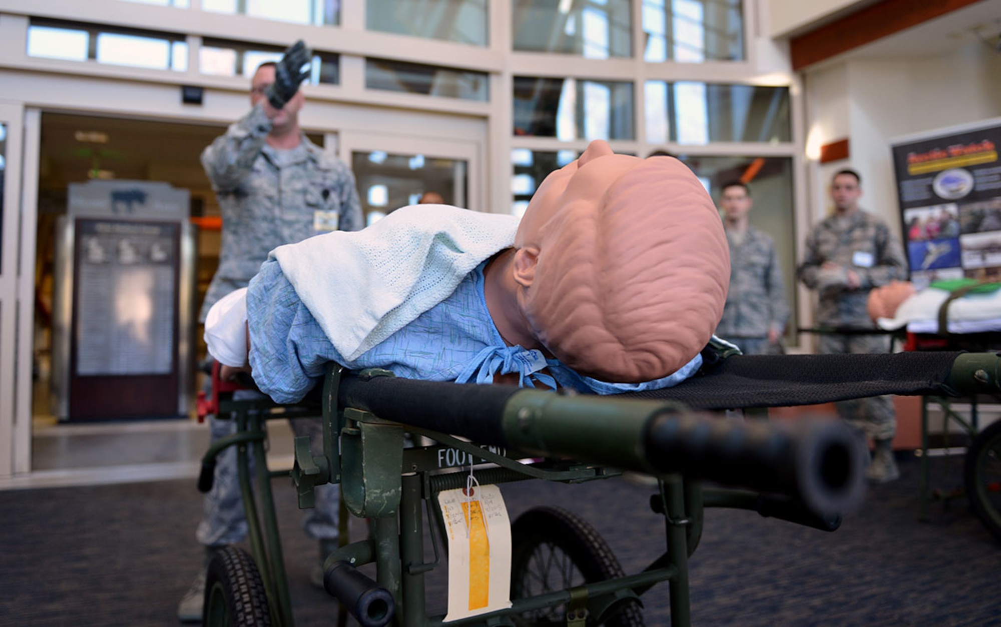 673d Medical Group personnel prepare to load patients onto a waiting bus outside the 673d MDG for their first localized en-route patient staging system training at the Elmendorf Physical Fitness Center April 21. The ERPSS is designed to act as a temporary staging location for patients the hospital does not have room for in the event of a major incident before being flown out of the area. (U.S. Air Force photo by Airman 1st Class Kyle Johnson)