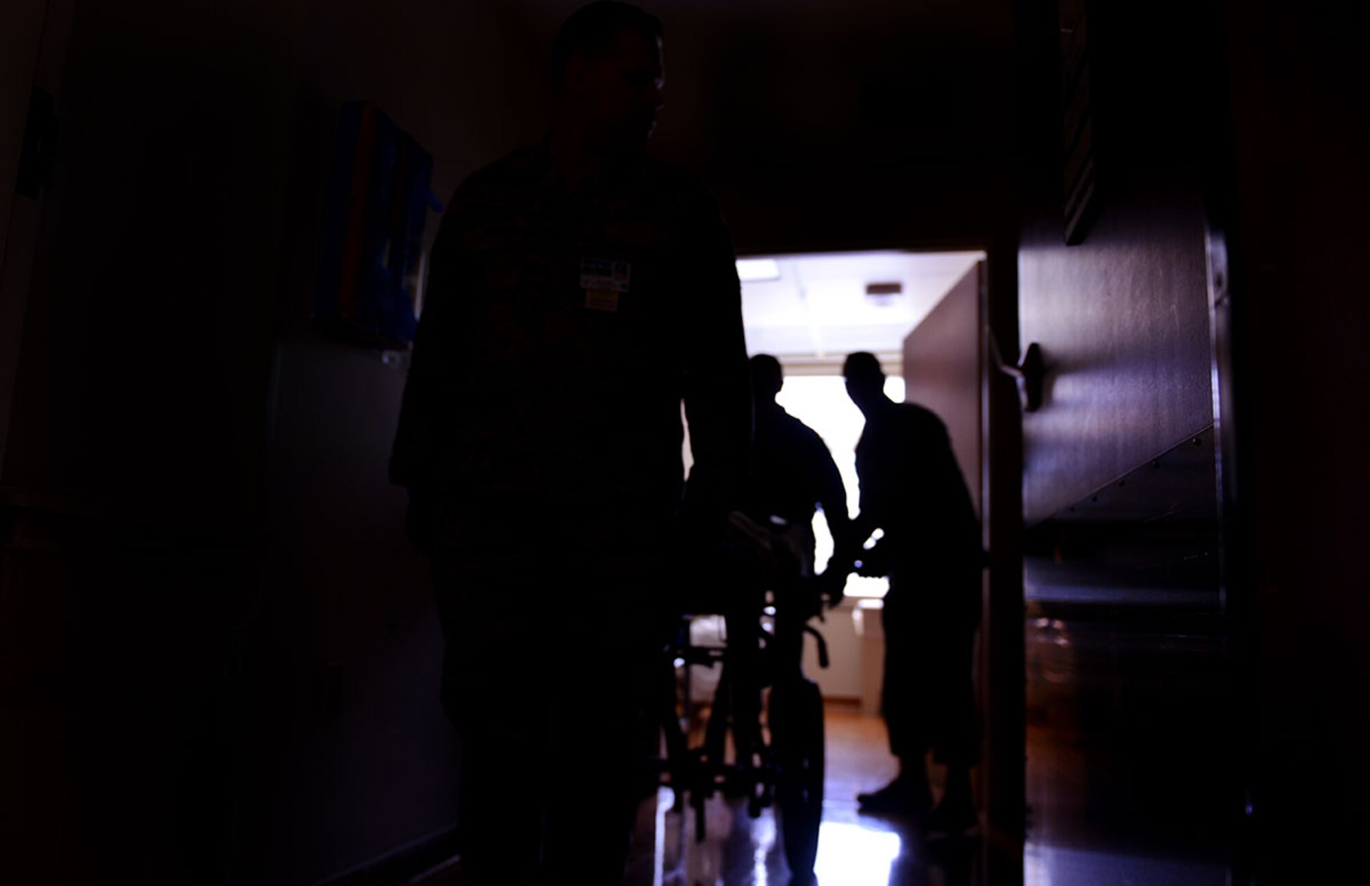 673d Medical Group personnel begin the process of moving patients out of the hospital during their first localized en-route patient staging system training at the Elmendorf Physical Fitness Center April 21. The ERPSS is designed to act as a temporary staging location for patients the hospital does not have room for in the event of a major incident before being flown out of the area. (U.S. Air Force photo by Airman 1st Class Kyle Johnson)