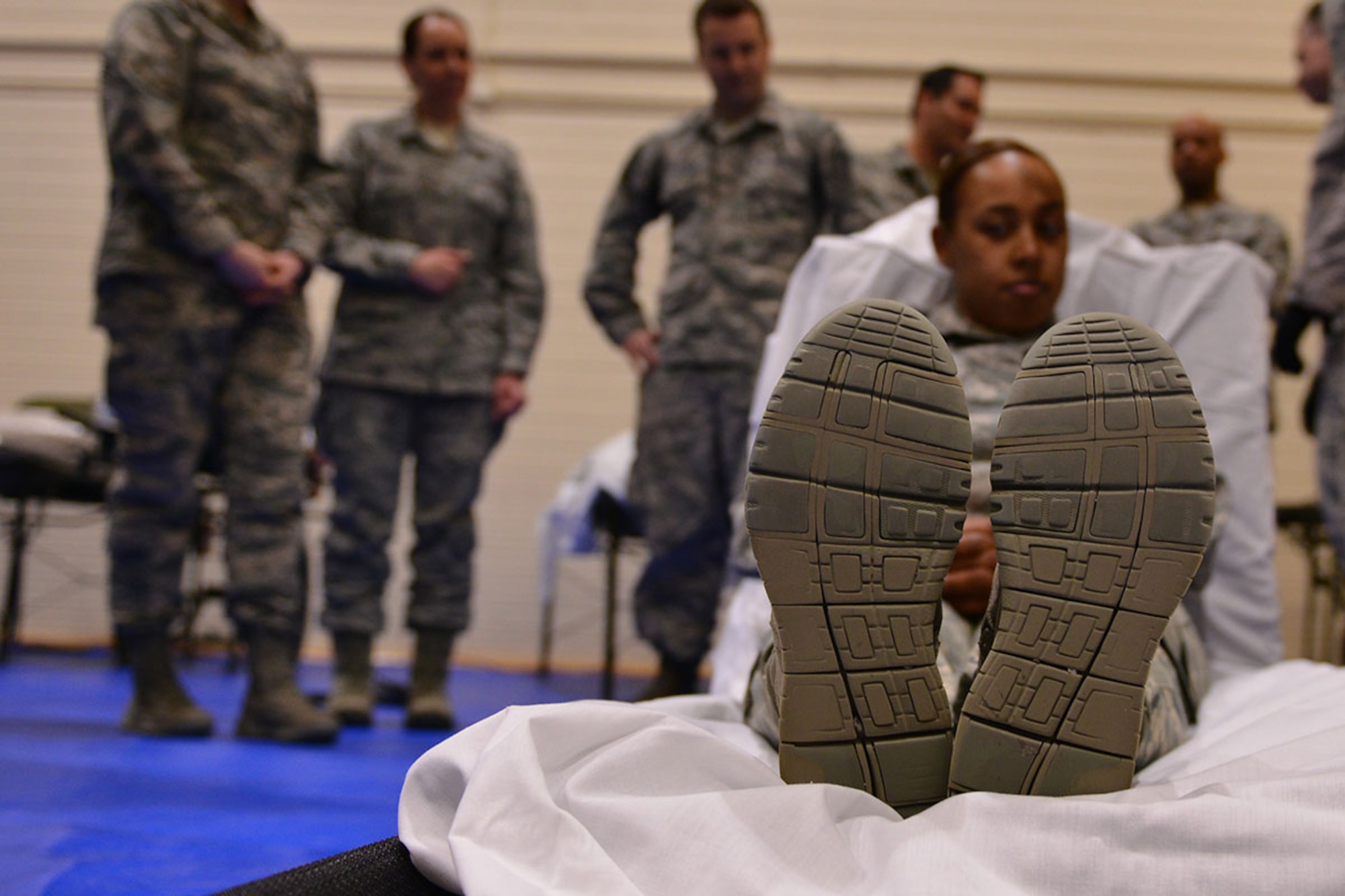 Senior Airman Natasha Mullins acts as a patient at the 673d Medical Group’s first localized en-route patient staging system training at the Elmendorf Physical Fitness Center April 21. The ERPSS is designed to act as a temporary staging location for patients the hospital does not have room for in the event of a major incident before being flown out of the area. (U.S. Air Force photo by Airman 1st Class Kyle Johnson)