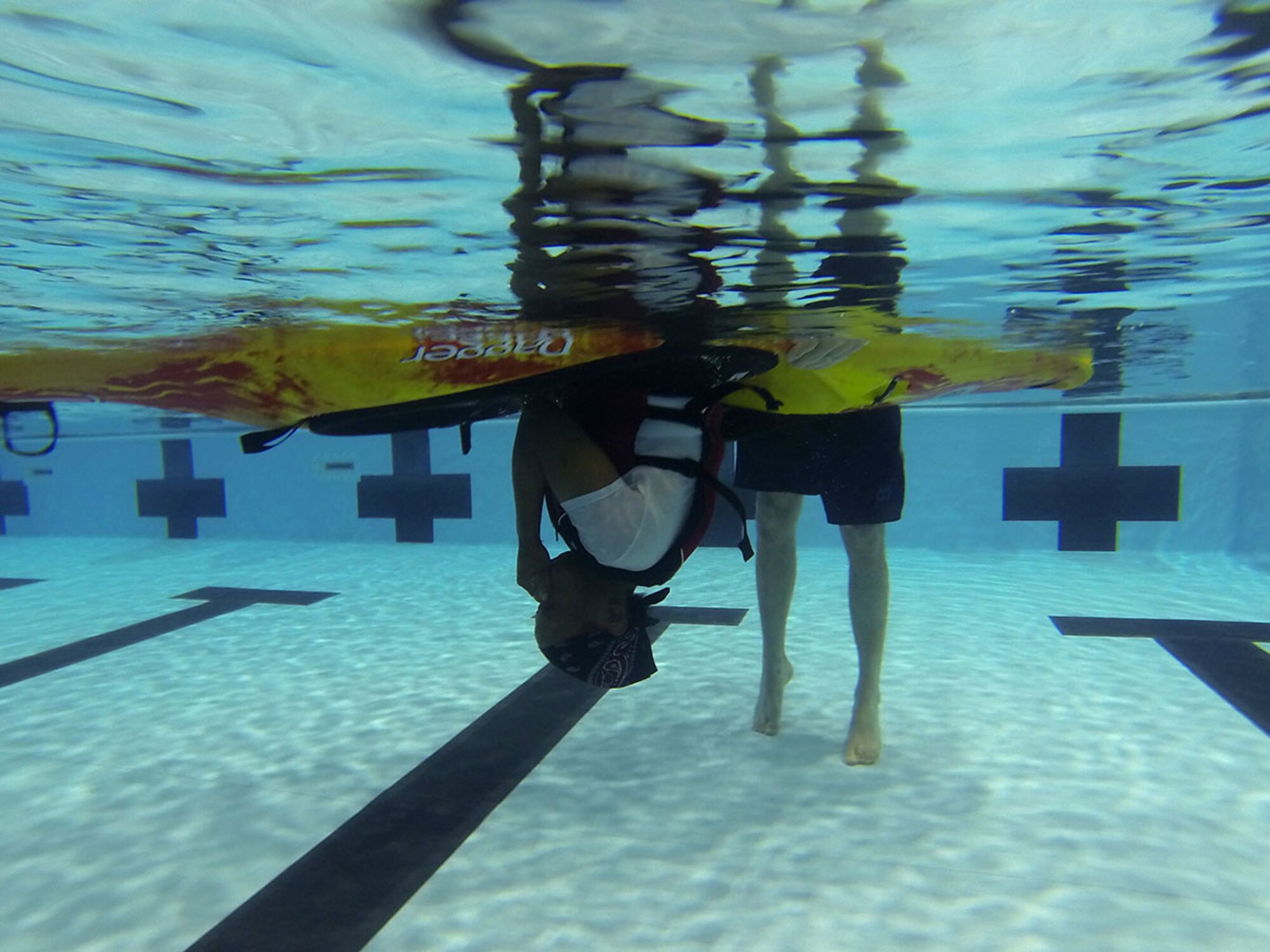 Jacoba Merschoff holds her breath underwater to become more comfortable rolling at the Joint Base Elmendorf-Richardson Elmendorf Fitness Center pool, April 15, 2016. Army Staff Sgt. Timothy Merschoff, F Company, 2nd Battalion 377th Parachute Field Artillery Regiment, 4th Infantry Brigade Combat Team (Airborne), 25th Infantry Division, brought his wife, Jacoba, and daughter, Kiley, to learn how to roll in a kayak for their upcoming summer trips. (U.S. Air Force photo by Airman 1st Class Christopher R. Morales)