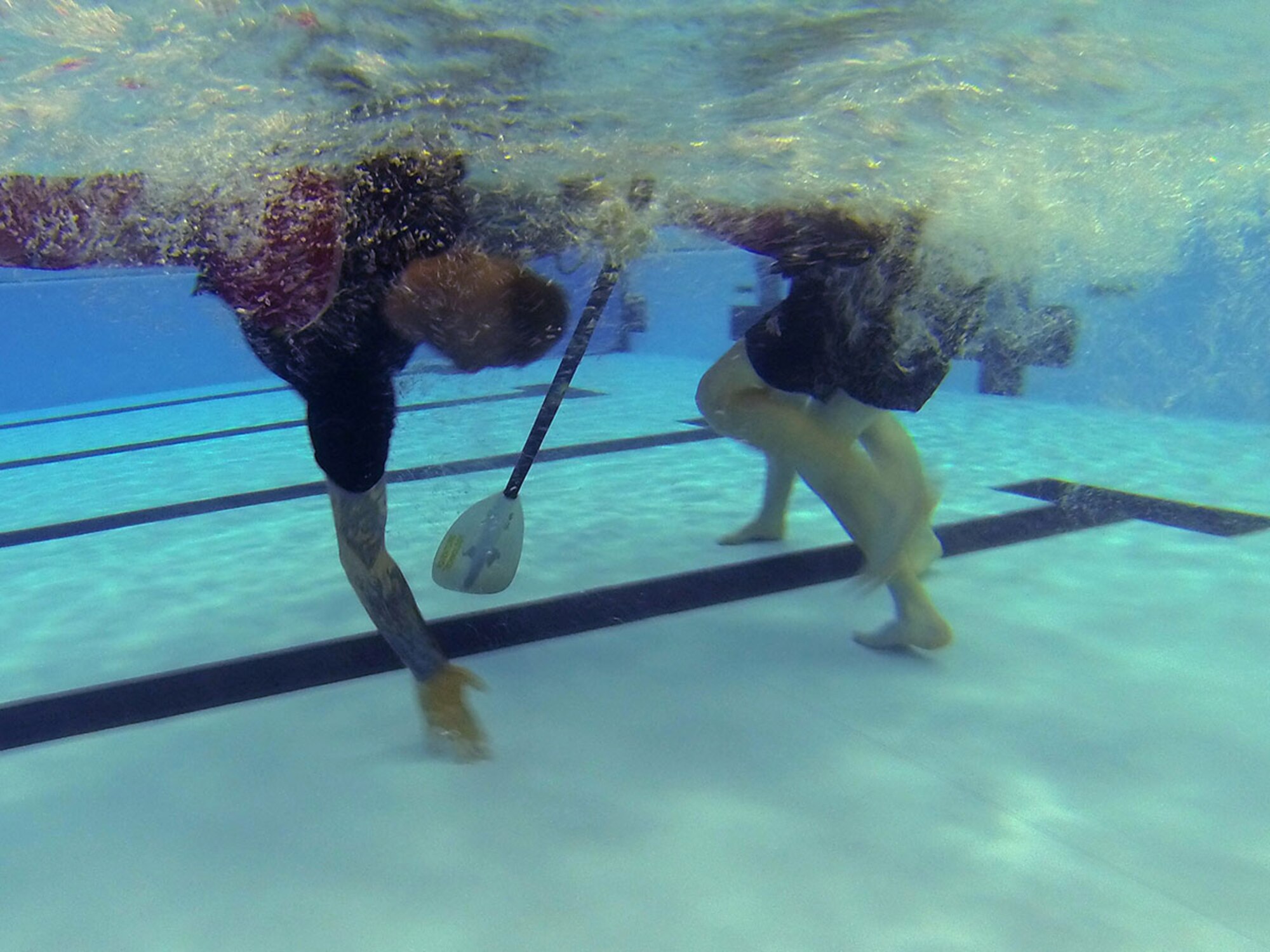 Army Staff Sgt. Timothy Merschoff, F Company, 2nd Battalion 377th Parachute Field Artillery Regiment, 4th Infantry Brigade Combat Team (Airborne), 25th Infantry Division, attempts to roll above the water at the Joint Base Elmendorf-Richardson Elmendorf Fitness Center pool, April 15, 2016. Merschoff practiced many times resulting in a rush of help from others to flip the kayak. (U.S. Air Force photo by Airman 1st Class Christopher R. Morales)