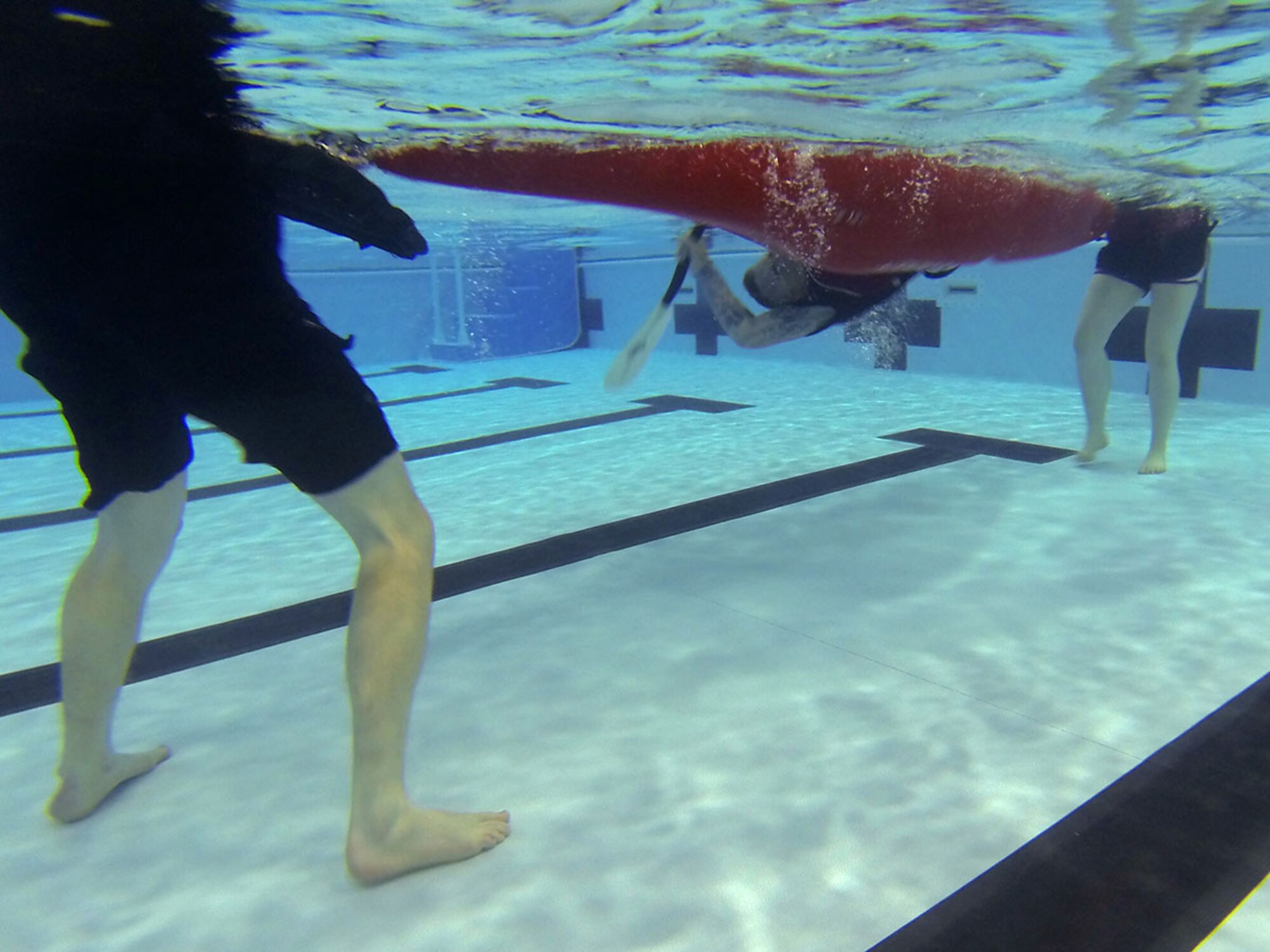 Army Staff Sgt. Timothy Merschoff, F Company, 2nd Battalion 377th Parachute Field Artillery Regiment, 4th Infantry Brigade Combat Team (Airborne), 25th Infantry Division, rolls under the water with help at the Joint Base Elmendorf-Richardson Elmendorf Fitness Center pool, April 15, 2016. Merschoff practiced many times, but eventually got it in the end. (U.S. Air Force photo by Airman 1st Class Christopher R. Morales)