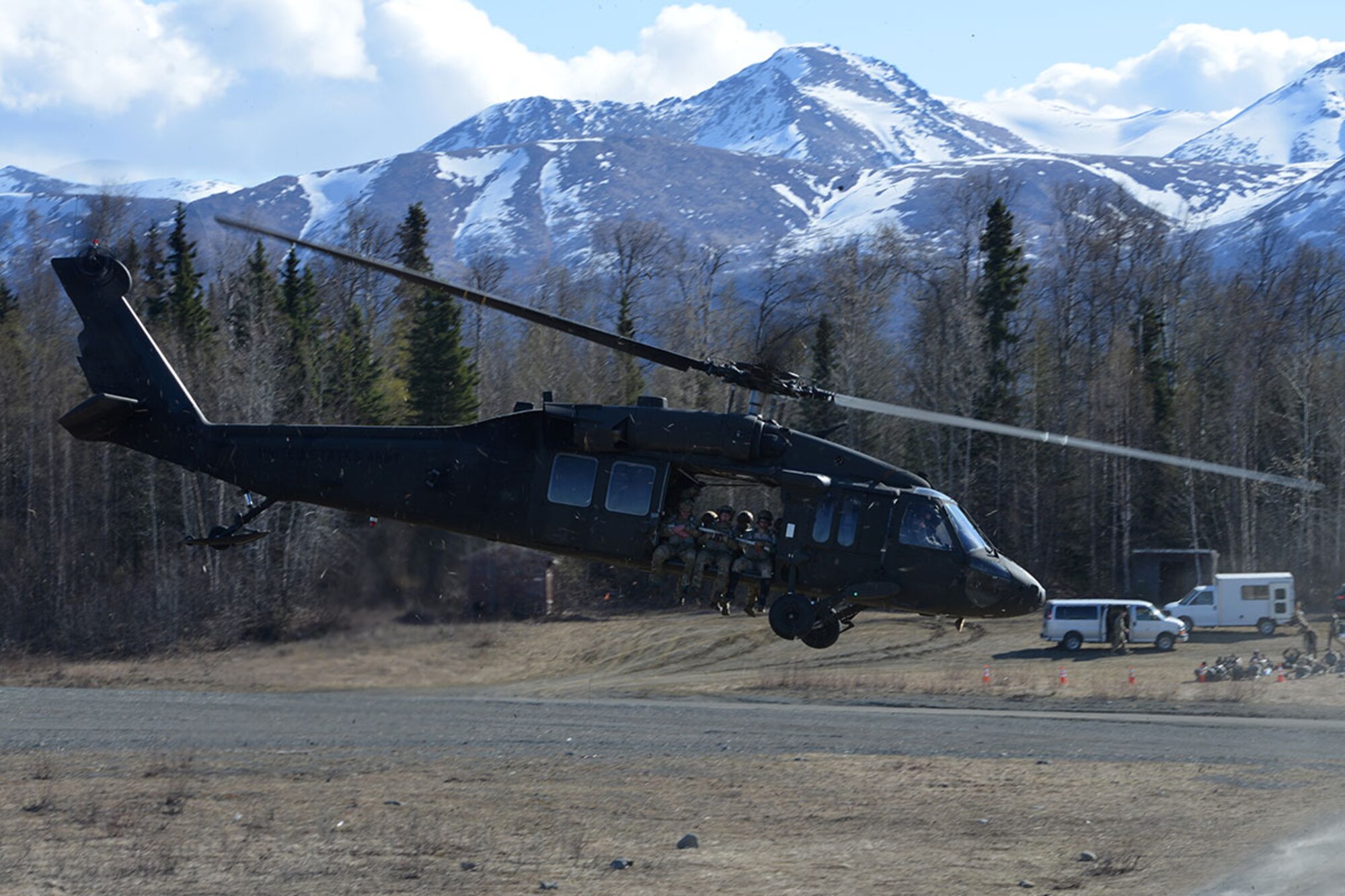 A UH-60 Black Hawk flown by the, 1st battalion, 52nd Aviation Regiment, U.S. Army Alaska Aviation Task Force, ascends at Malemute Drop Zone, on Joint Base Elmendorf-Richardson, Alaska, April 18, 2016. Two Black Hawks carried 64 jumpers in 12 passes to kick off the Jump Week training exercise. (U.S. Air Force photo by Airman 1st Class Javier Alvarez)