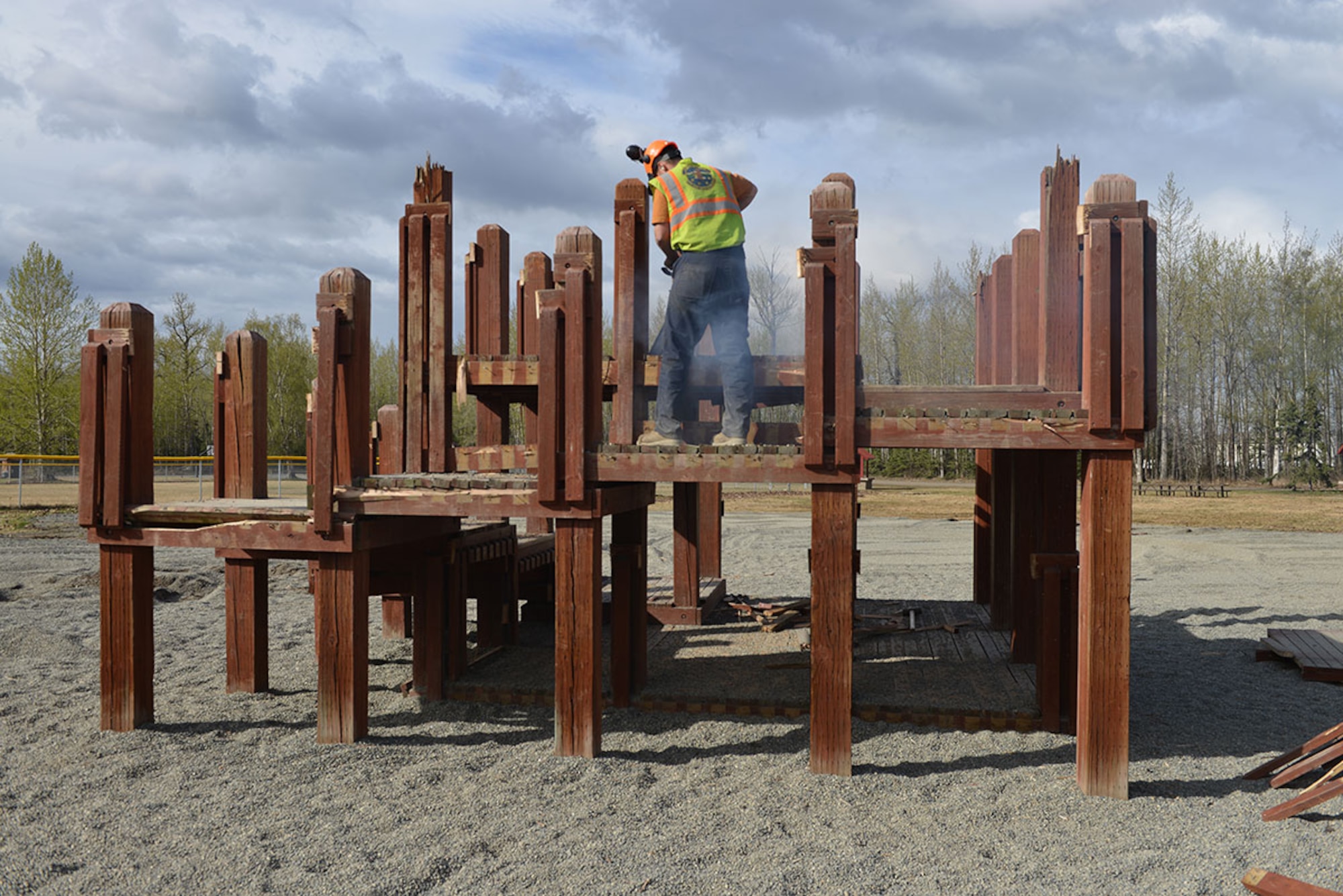 Levi Tressel, 773d Civil Engineer Squadron heavy equipment operator, uses a chainsaw to remove a play structure at the Cottonwood Park playground on Joint Base Elmendorf-Richardson, Alaska, April 26, 216. Construction of the new playground will begin May 1, with expected completion in late September. (U.S. Air Force photo by Airman 1st Class Javier Alvarez)
