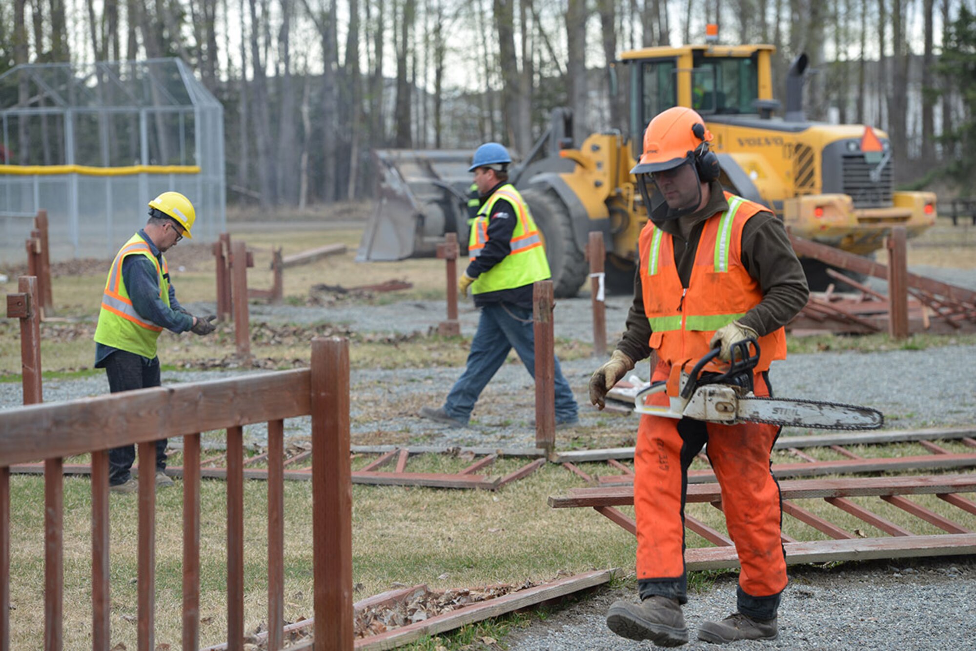 Personnel of the 773d Civil Engineer Squadron work to tear down the wood fence at the Cottonwood Park playground on Joint Base Elmendorf-Richardson, Alaska, April 25, 2016.  Demolition completion is scheduled for April 28. (U.S. Air Force photo by Airman 1st Class Javier Alvarez)