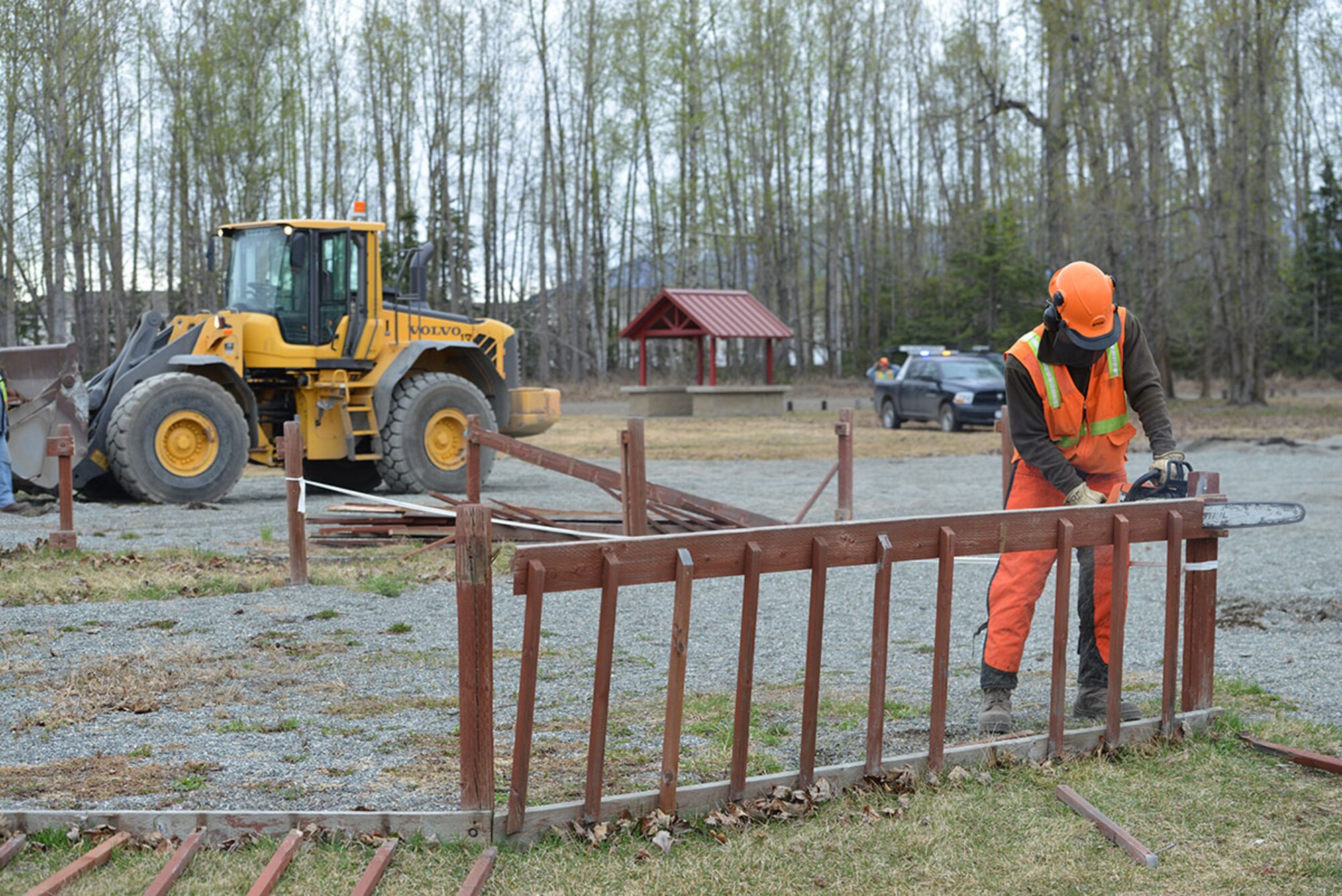 Jona Briggs, 773d Civil Engineer Squadron heavy equipment operator, uses a chainsaw to cut down the fence at the playground at Cottonwood Park, Joint Base Elmendorf-Richardson, Alaska, April 25, 2016. Construction of the new playground at Cottonwood Park is scheduled to begin May 1, 2016. (U.S. Air Force photo by Airman 1st Class Javier Alvarez)