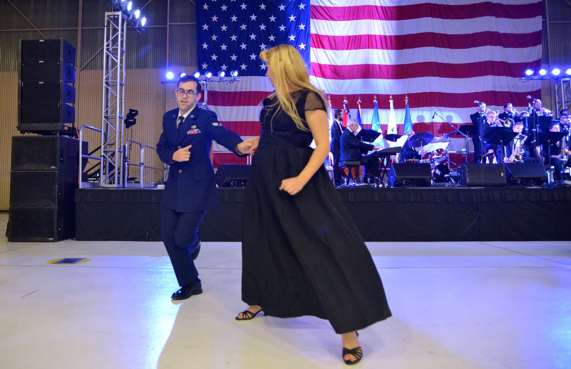 Senior Airman Jeffrey Whitlock and his swing partner dance the night away at an April 16 banquet celebrating Kirtland's 75th anniversary. About 500 people attended the banquet at the New Mexico Air National Guard’s 150th Special Operations Wing hangar. The banquet had a 1940s theme, to remember the opening of Albuquerque Army Air Base on Jan. 7, 1941. Period attire and static displays of World War II vehicles helped bring the theme to life. (Photo by Todd Berenger)