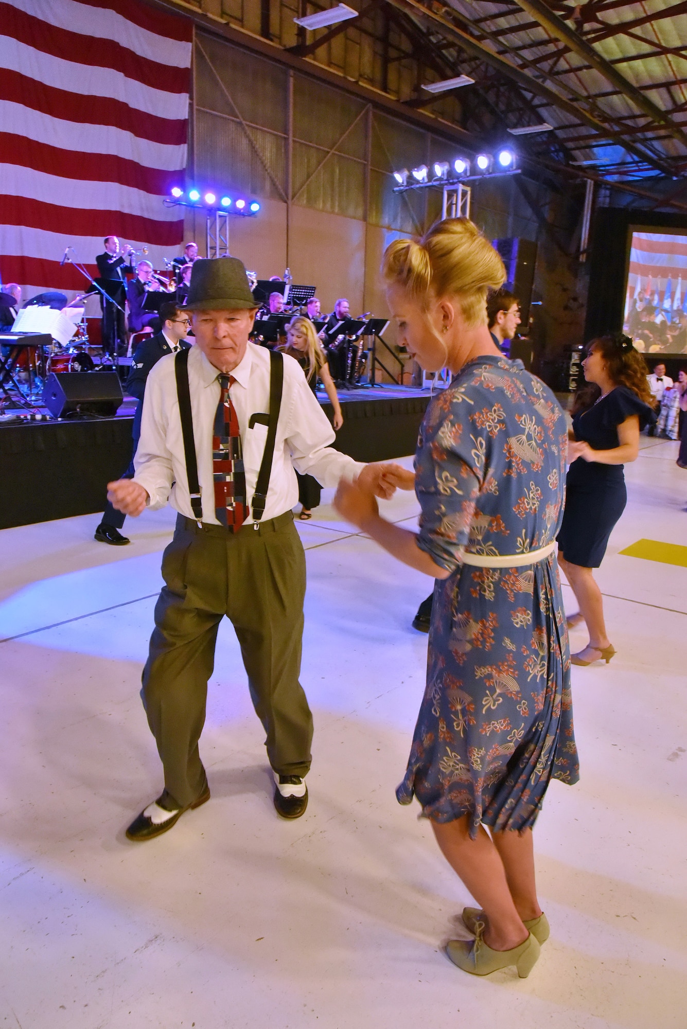 80-year-old David Windle and his guest Brynn Cole dance the night away at an April 16 banquet celebrating Kirtland's 75th anniversary. About 500 people attended the banquet at the New Mexico Air National Guard’s 150th Special Operations Wing hangar. The banquet had a 1940s theme, to remember the opening of Albuquerque Army Air Base on Jan. 7, 1941. Period attire and static displays of World War II vehicles helped bring the theme to life. (Photo by Ken Moore)
