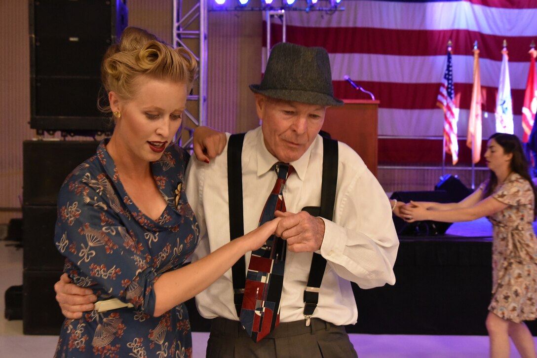 80-year-old David Windle and his guest Brynn Cole dance the night away at an April 16 banquet celebrating Kirtland's 75th anniversary. About 500 people attended the banquet at the New Mexico Air National Guard’s 150th Special Operations Wing hangar. The banquet had a 1940s theme, to remember the opening of Albuquerque Army Air Base on Jan. 7, 1941. Period attire and static displays of World War II vehicles helped bring the theme to life. (Photo by Ken Moore)
