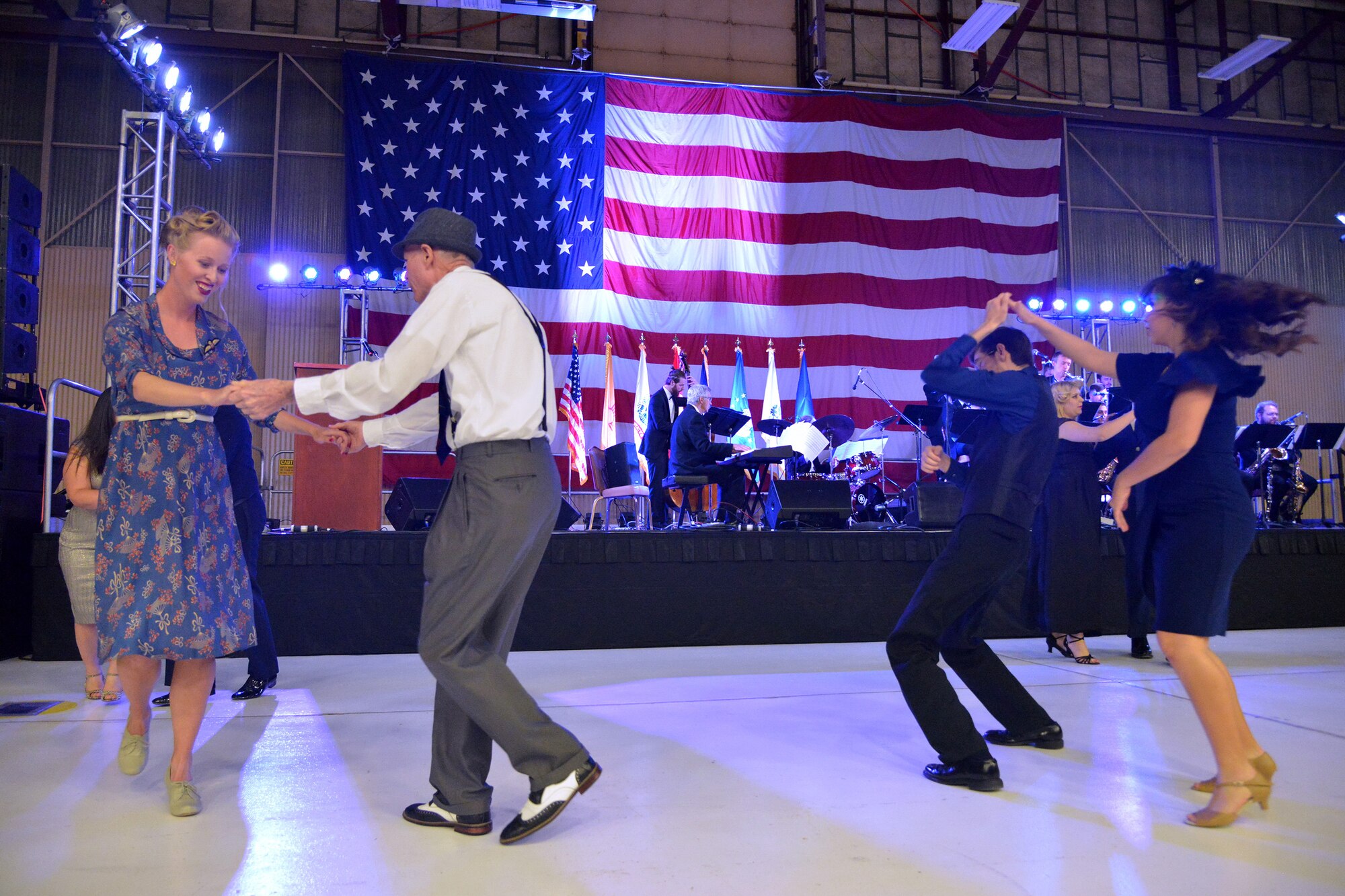 Couples take the dance floor at the 75th Anniversary banquet April 16. About 500 people attended the banquet at the New Mexico Air National Guard’s 150th Special Operations Wing hangar. The banquet had a 1940s theme, to remember the opening of Albuquerque Army Air Base on Jan. 7, 1941. Period attire and static displays of World War II vehicles helped bring the theme to life. (Photo by Todd Berenger)