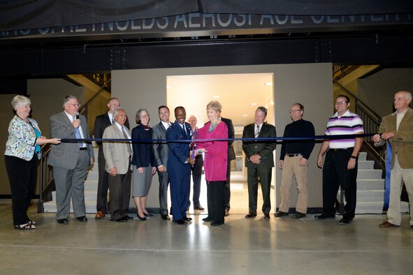 Col. Ron Jolly, 75th Air Base Wing commander, and Ellie Reynolds, spouse of the late Lt. Gen. Marc C. Reynolds, cut the ribbon opening the newly constructed Lieutenant General Marc C. Reynolds Aerospace Center for Education April 27 at the Hill Aerospace Museum. The naming of the Lieutenant General Marc C. Reynolds Aerospace Center of Education recognizes an individual who served as Board Chair of the Aerospace Heritage Foundation of Utah for more than twenty years. (U.S. Air Force photo by Todd Cromar)