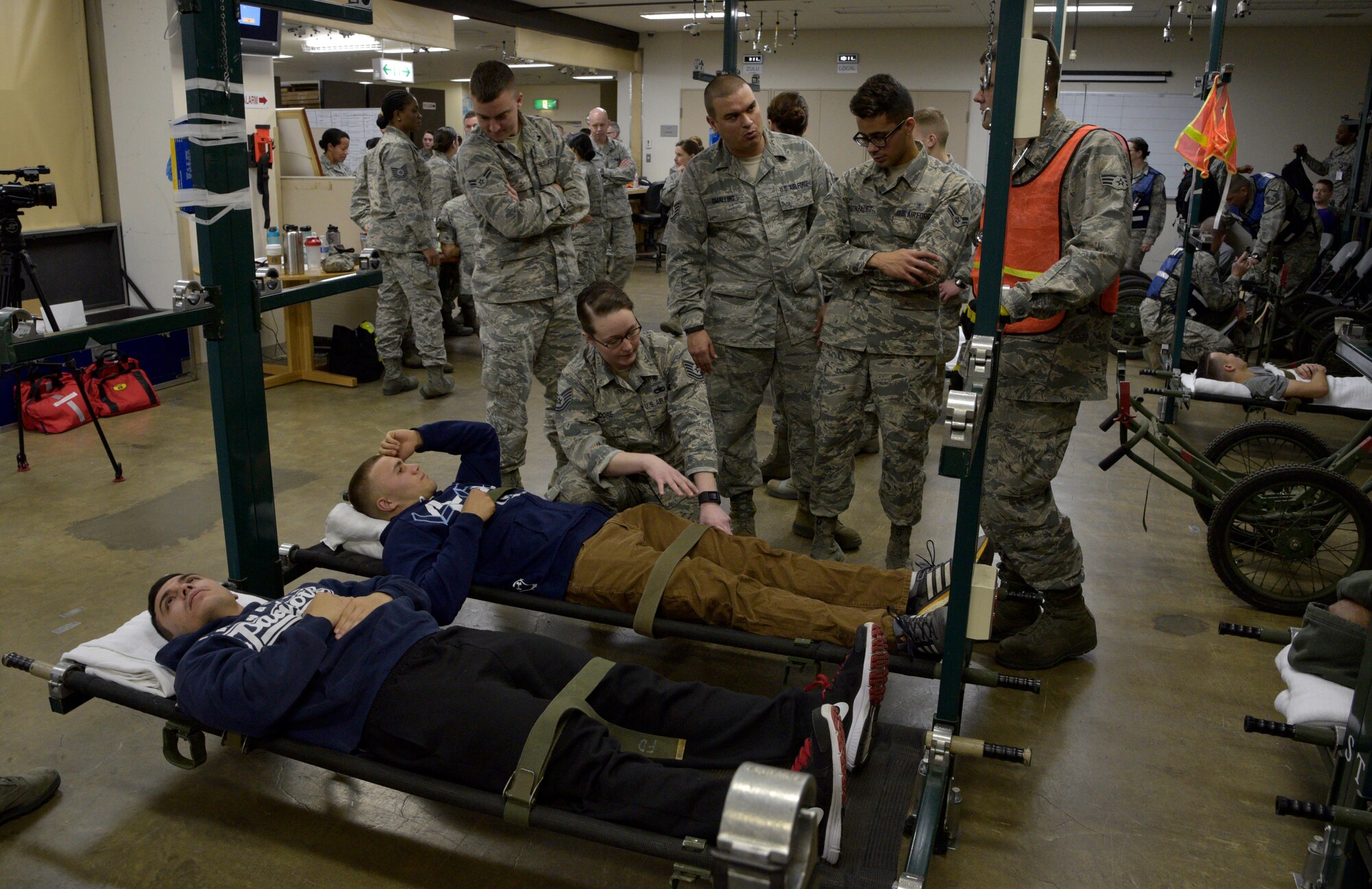 Airmen from the 35th Medical Group tend to two personnel simulating injuries during an emergency management exercise at Misawa Air Base, Japan, April 27, 2016. Aftershocks following a simulated 8.2 magnitude earthquake forced the 35 MDG to hold injured personnel in their expansion bay to be air-evacuated to another base for care. (U.S. Air Force photo by Senior Airman Patrick S. Ciccarone)
