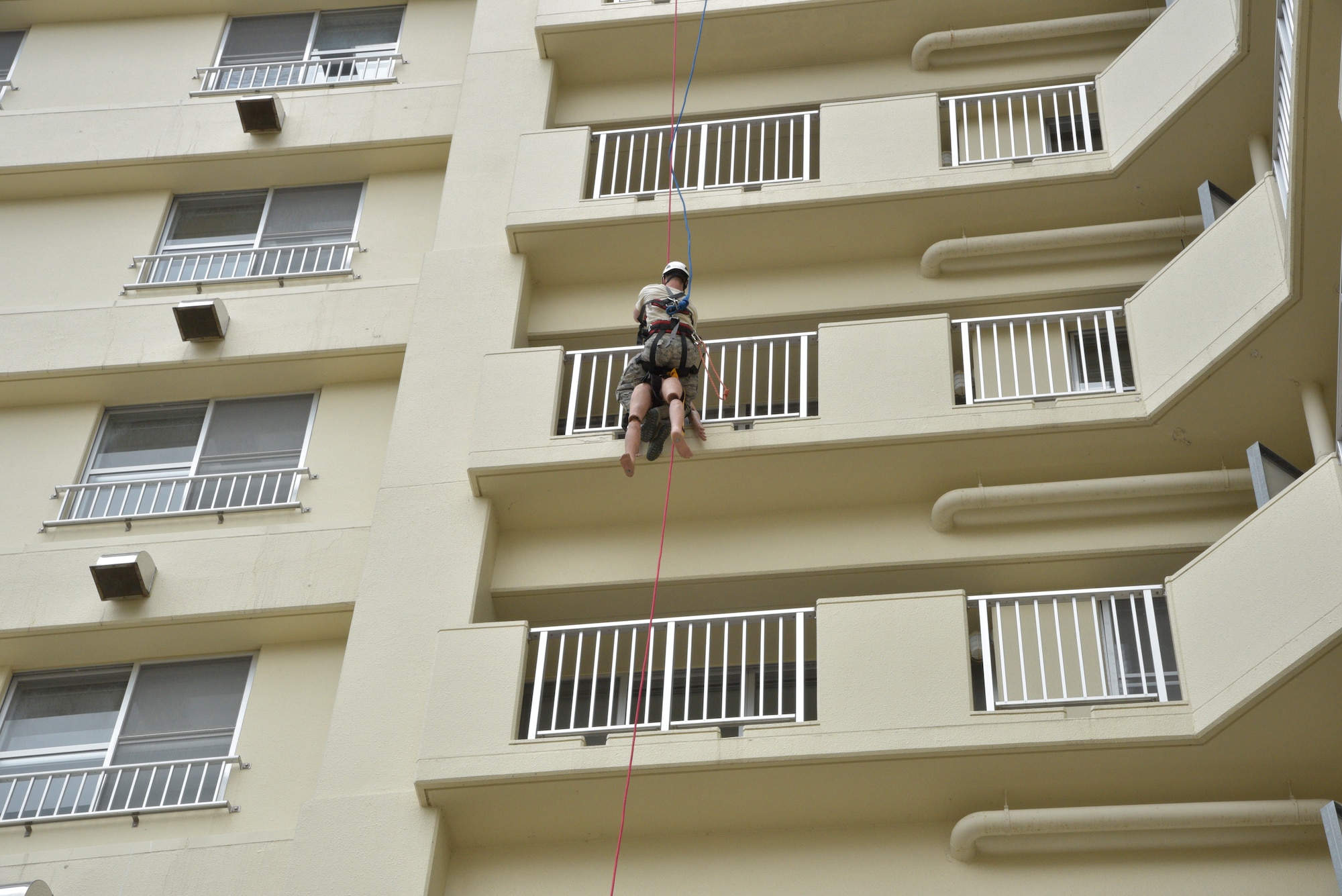 U.S. Air Force Staff Sgt. Corey Loesch, 35th Civil Engineer Squadron Fire Department crew chief, rappels down the side of a housing tower during an emergency management exercise at Misawa Air Base, Japan, April 26, 2016. Loesch and other members of the fire department composed a rescue team assembled to save the life of a simulated injured person who was clinging to a balcony following an earthquake. (U.S. Air Force photo by Senior Airman Patrick S. Ciccarone)
