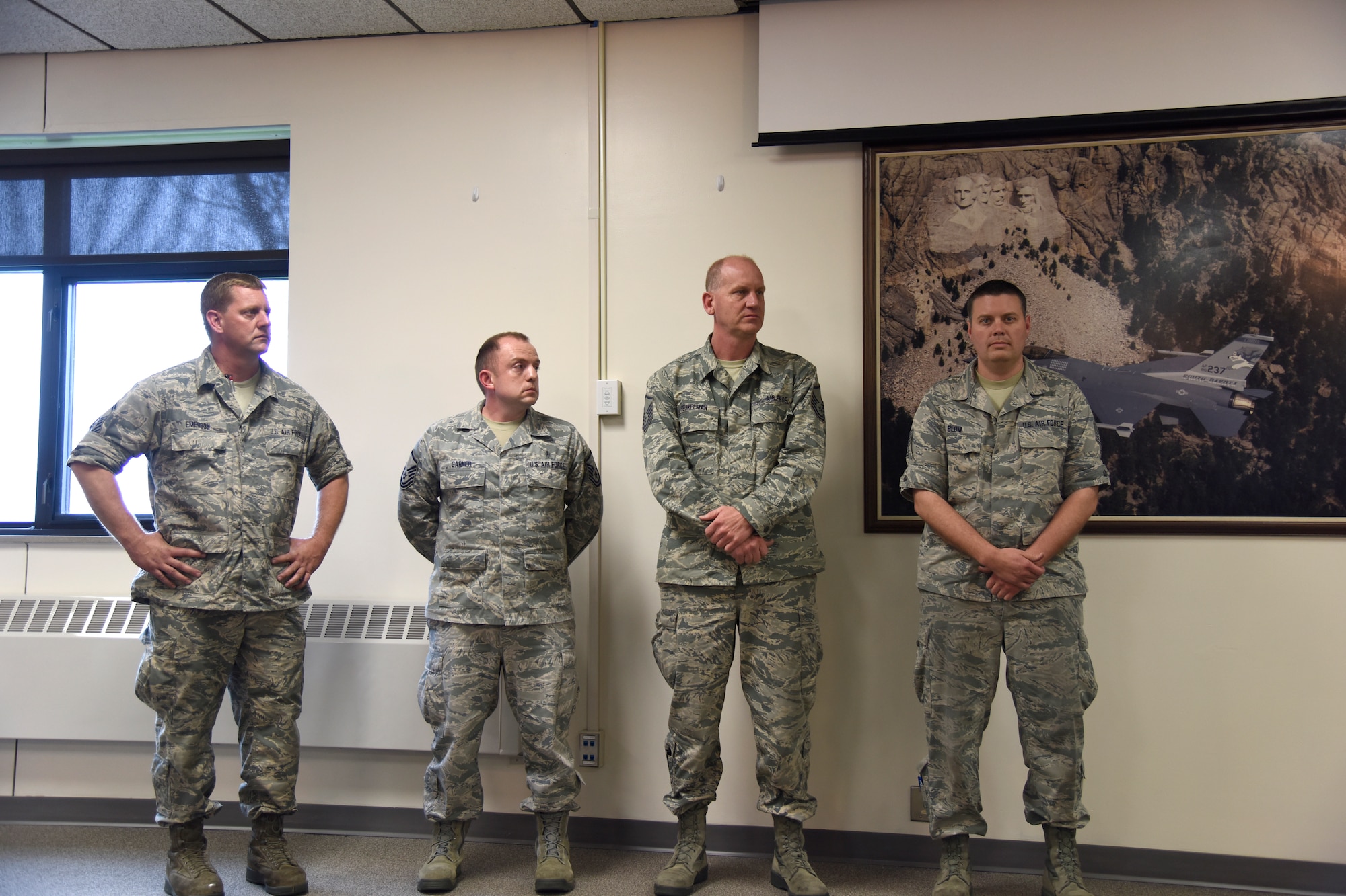 SIOUX FALLS, S.D. - Pictured left to right, Senior Master Sgt. Shawn Emerson, Master Sgt. Brent Garner, Master Sgt. Paul Beukelman, and Tech. Sgt. Nate Blom, all full-time employees of the South Dakota Air National Guard, listen as Col. Nate Alholinna, 114th Fighter Wing vice commander, reads a letter from Lutheran Social Services commending the Airmen for the time they spent as mentors over the past year. Master Sgt. Casey Bullis is also a mentor under this program but was not available for the photograph.(U.S. National Guard photo by Senior Master Sgt. Nancy Ausland)