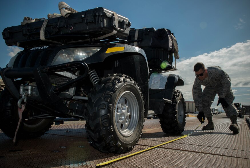 Airman 1st Class Mason Mcanear, 821st Contingency Response Squadron, measures an all-terrain vehicle during a joint inspection before it was loaded onto a C-17 Globemaster lll aircraft before departing Travis Air Force Base, Calif., to support earthquake response efforts in Ecuador, April 21, 2016. The 621st Contingency Response Wing is providing an assessment team that includes subject matter liaisons in the realms of aerial port operations, cargo movement, material handling equipment, and communications. The 621st CRW maintains a ready corps of light, lean and agile mobility support forces able to respond as directed in order to meet combatant command requirements for humanitarian aid operations. (U.S. Air Force photo by Staff Sgt. Robert Hicks/Released)   