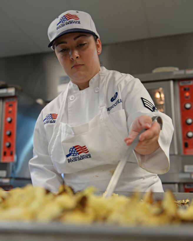 U.S. Air Force Senior Airman Jordyn R. Descoteaux, 157th Force Support Squadron Sustainment Services Flight services journeyman, prepares food during the unit training assembly, April 2, 2016, Pease Air National Guard Base, N.H. (U.S. Air National Guard photo by Staff Sgt. Curtis J. Lenz)