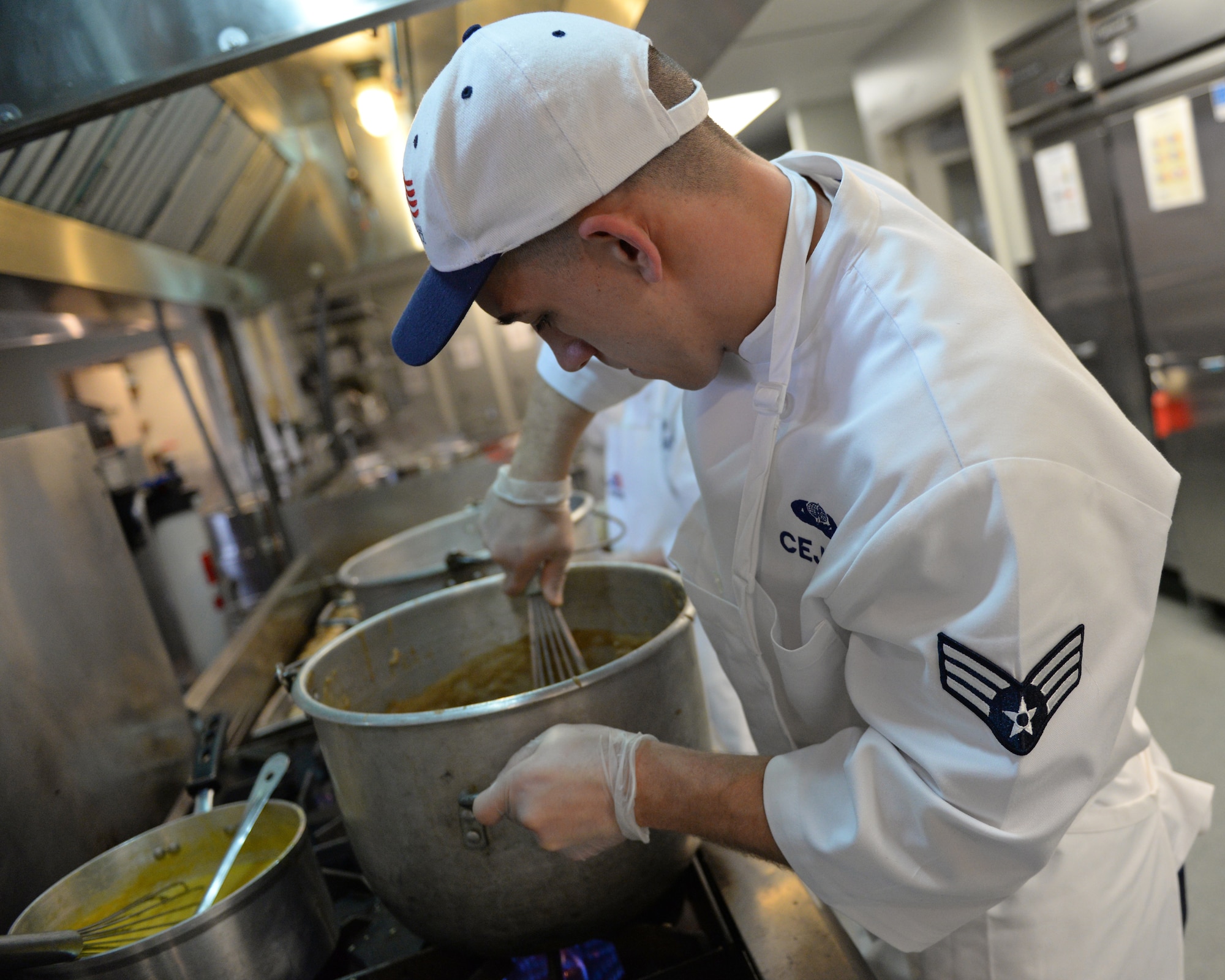 U.S. Air Force Senior Airman Caleb D. Cejka, 157th Force Support Squadron Sustainment Services Flight services journeyman, prepares food during the unit training assembly, April 2, 2016, Pease Air National Guard Base, N.H. (U.S. Air National Guard photo by Staff Sgt. Curtis J. Lenz)