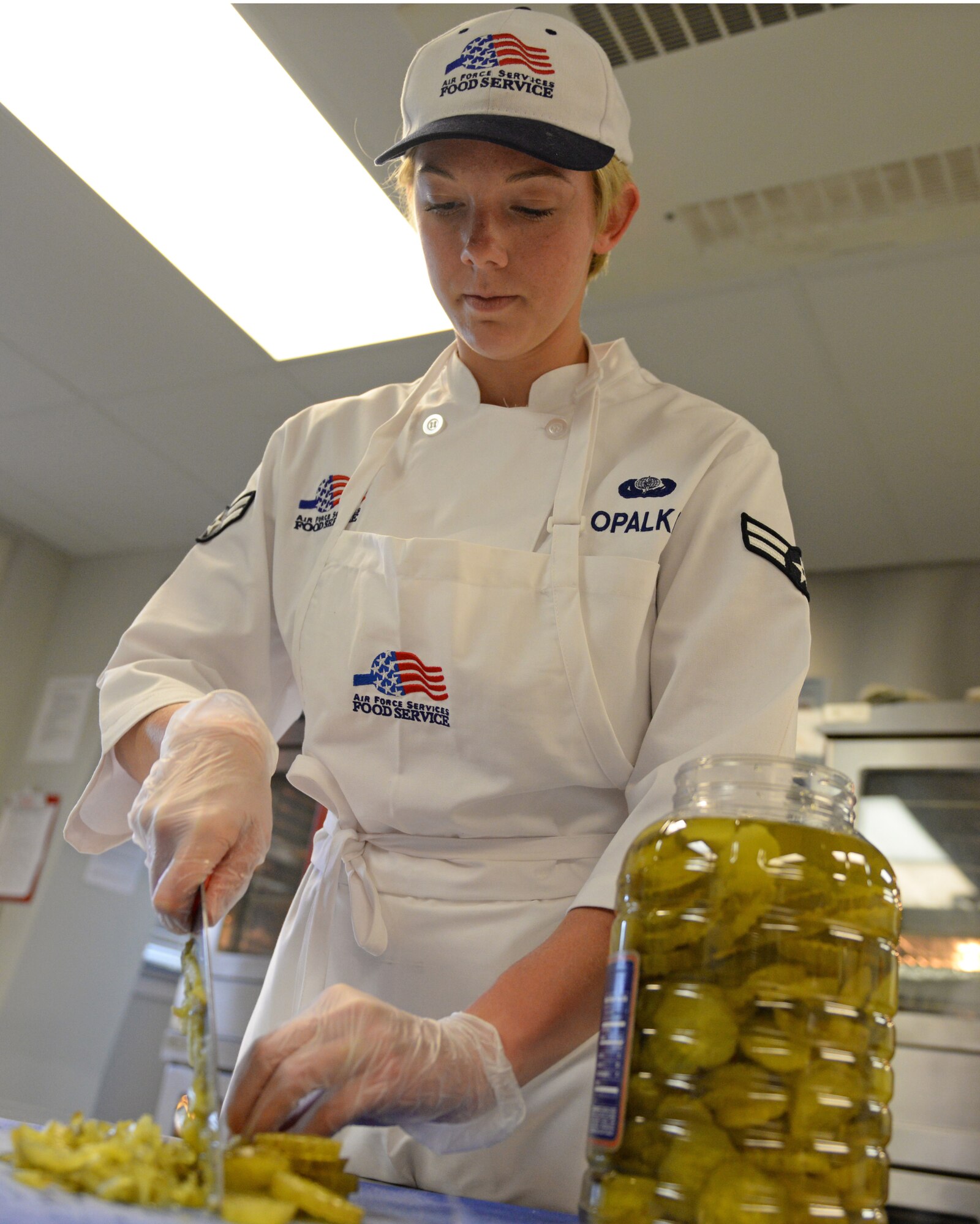 U.S. Air Force Airman 1st Class Melissa E. Opalka, 157th Force Support Squadron Sustainment Services Flight, prepares food during the unit training assembly, April 2, 2016, Pease Air National Guard Base, N.H. (U.S. Air National Guard photo by Staff Sgt. Curtis J. Lenz)