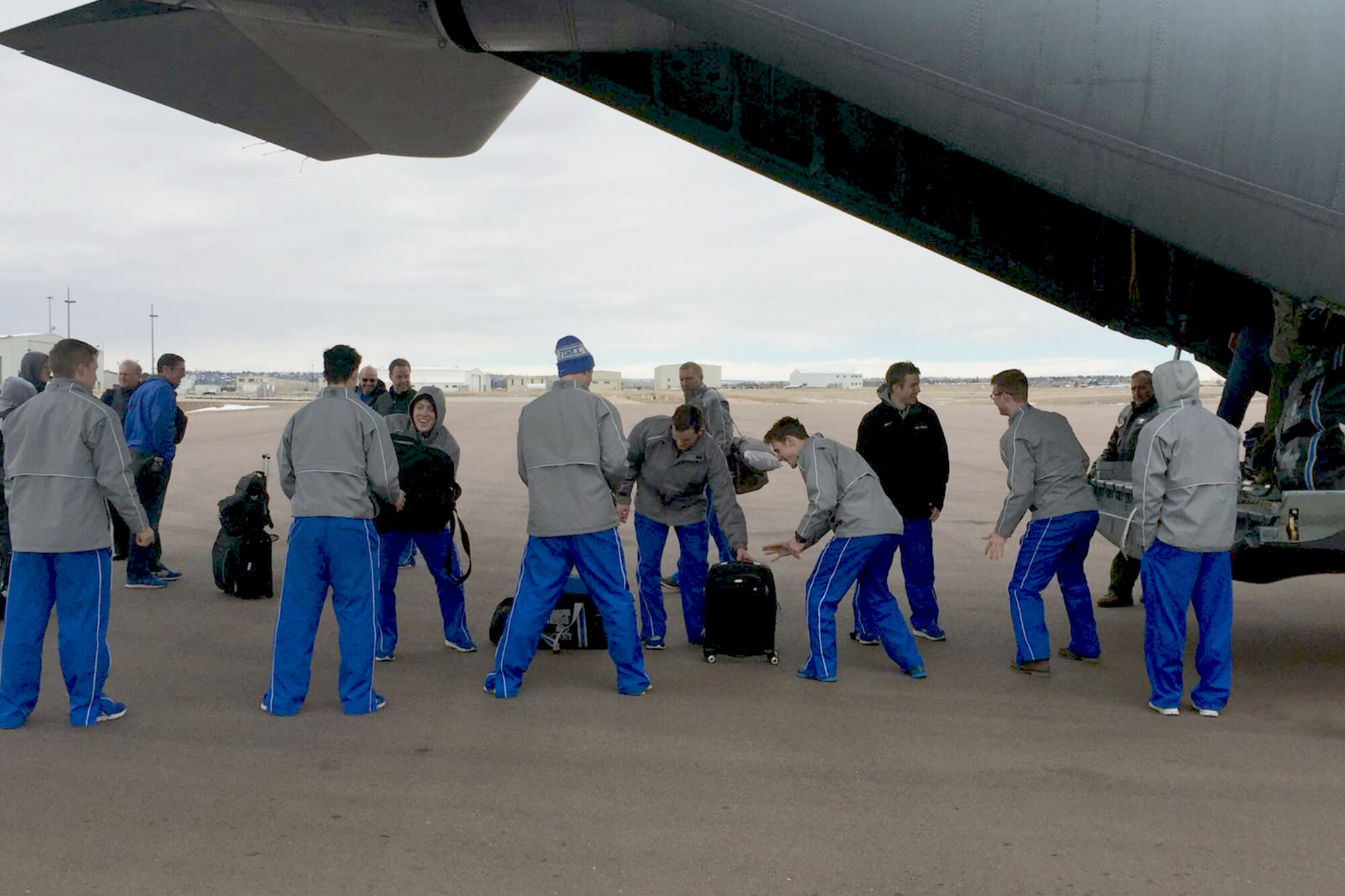 U.S. airmen of the 156th Operations Group, Puerto Rico Air National Guard, provide airlift transport on a WC-130 Hercules aircraft to the U.S. Air Force Academy ice hockey team from Rochester, N.Y. to Colorado Springs, Colo., Mar 19. As a unified team, the PRANG aircrew along with 47 Air Force Falcons team players and team personnel jointly loaded 3,000 pounds of hockey team equipment on the WC-130 for their 4 hours and 25 minutes flight to Colorado Spring. (U.S. Air National Guard photo by Maj. Luis Martinez)