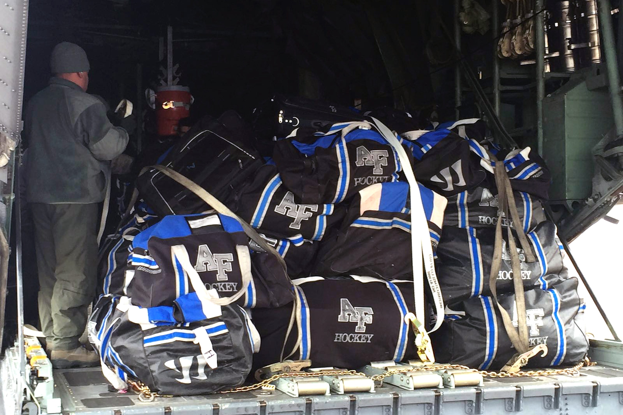 U.S. airmen of the 156th Operations Group, Puerto Rico Air National Guard, provide airlift transport on a WC-130 Hercules aircraft to the U.S. Air Force Academy ice hockey team from Rochester, N.Y. to Colorado Springs, Colo., Mar 19. As a unified team, the PRANG aircrew along with 47 Air Force Falcons team players and team personnel jointly loaded 3,000 pounds of hockey team equipment on the WC-130 for their 4 hours and 25 minutes flight to Colorado Spring.(U.S. Air National Guard photo by Maj. Luis Martinez)