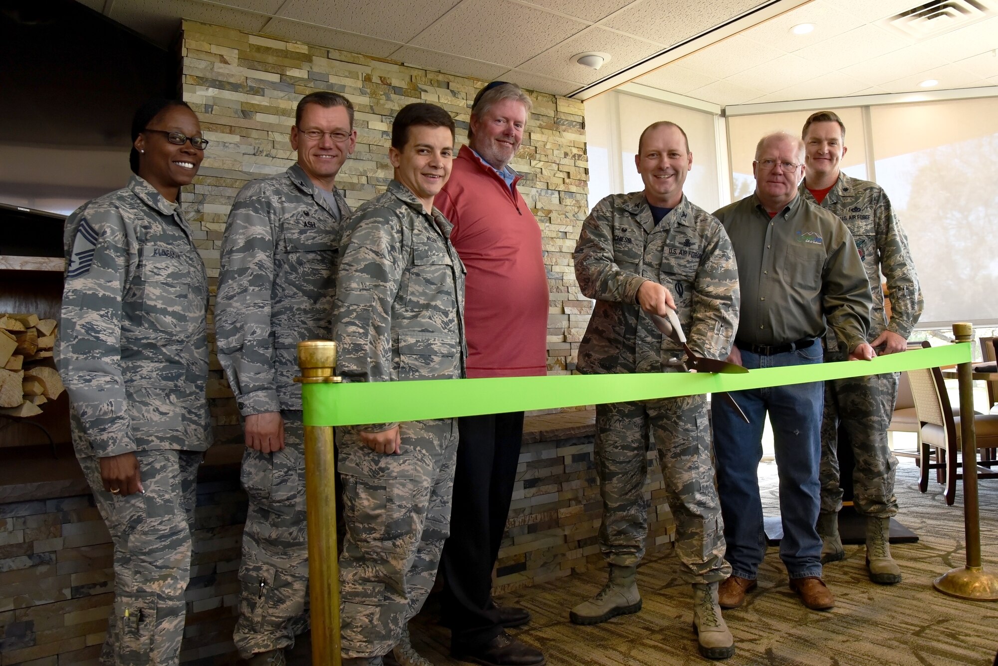PETERSON AIR FORCE BASE, Colo. – Col. Douglas Schiess, 21 Space Wing commander, and leadership from around the base take part in a ribbon cutting for the inaugural opening of the Greenside Grill and Smokehouse located at the Silver Spruce Golf Course at Peterson Air Force Base April 22. The Greenside Grill and Smokehouse features an indoor dining room and an outside patio, both with clear views of Colorado Springs and Pike’s Peak. (U.S. Air Force photo by Airman 1st Class Dennis Hoffman)
