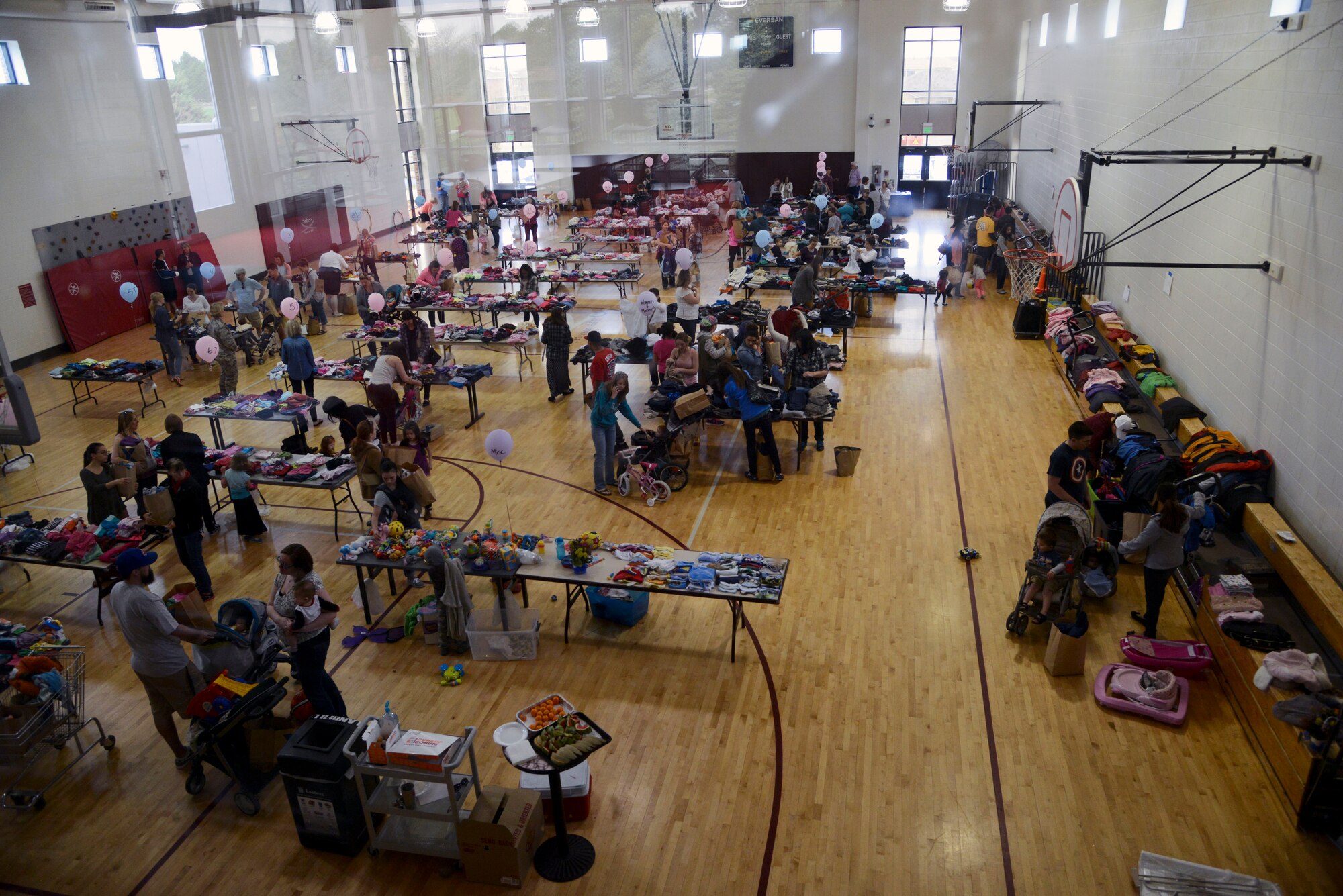 PETERSON AIR FORCE BASE, Colo. – Customers shop for free, donated clothing at the annual clothing swap at the Peterson Youth Center April 23, 2016. Selections ranged from newborn through teenager with maternity clothes and a toy per child also available. (U.S. Air Force photo by Master Sgt. Jared Marquis)