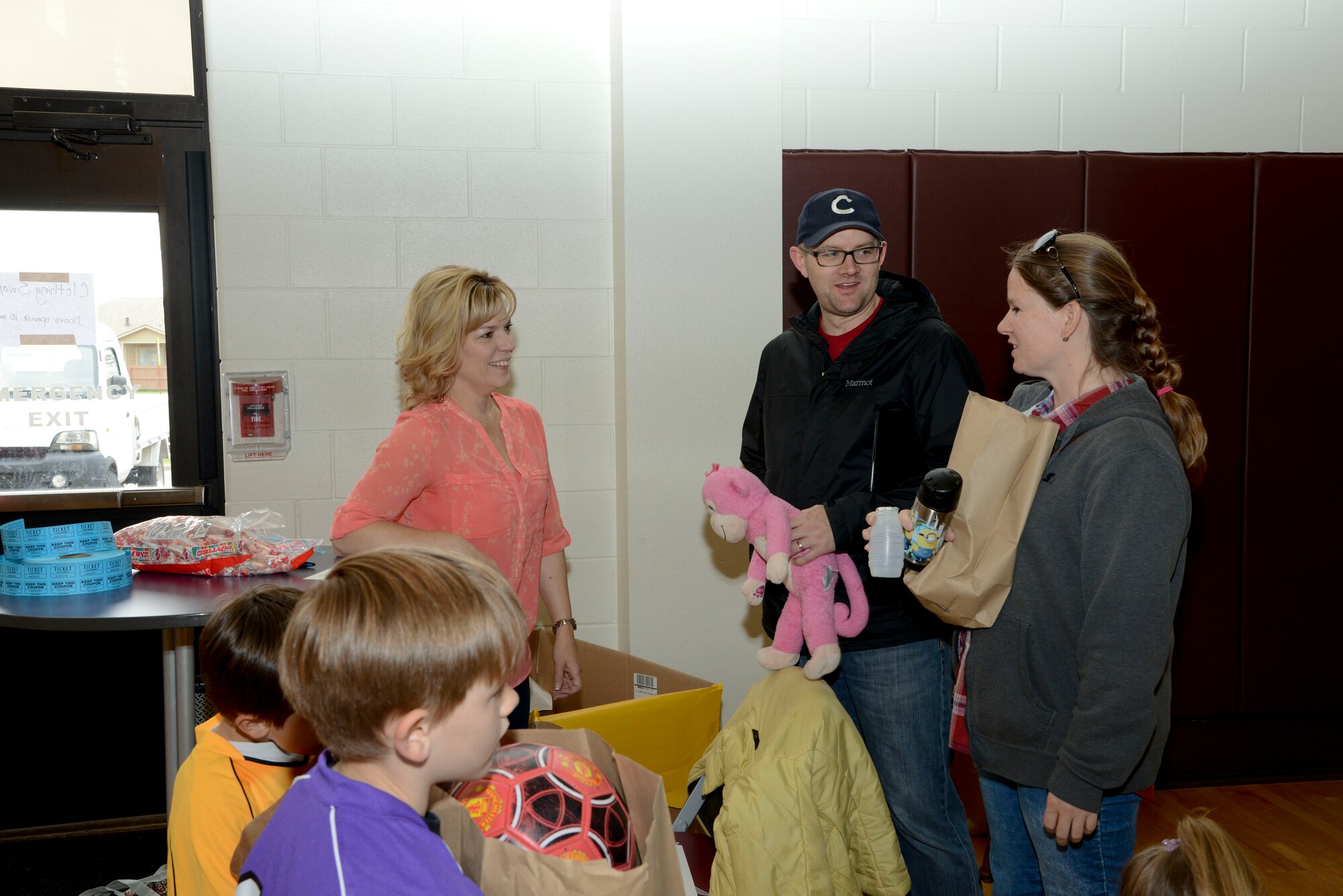 PETERSON AIR FORCE BASE, Colo. – Debbie Schiess (left), wife of Col. Doug Schiess, 21st Space Wing commander, greets customers of the Clothing Swap at the Peterson Youth Center April 23, 2016. Spouses and volunteers from Peterson and Schriever Air Force Bases organized the free event. (U.S. Air Force photo by Master Sgt. Jared Marquis)
