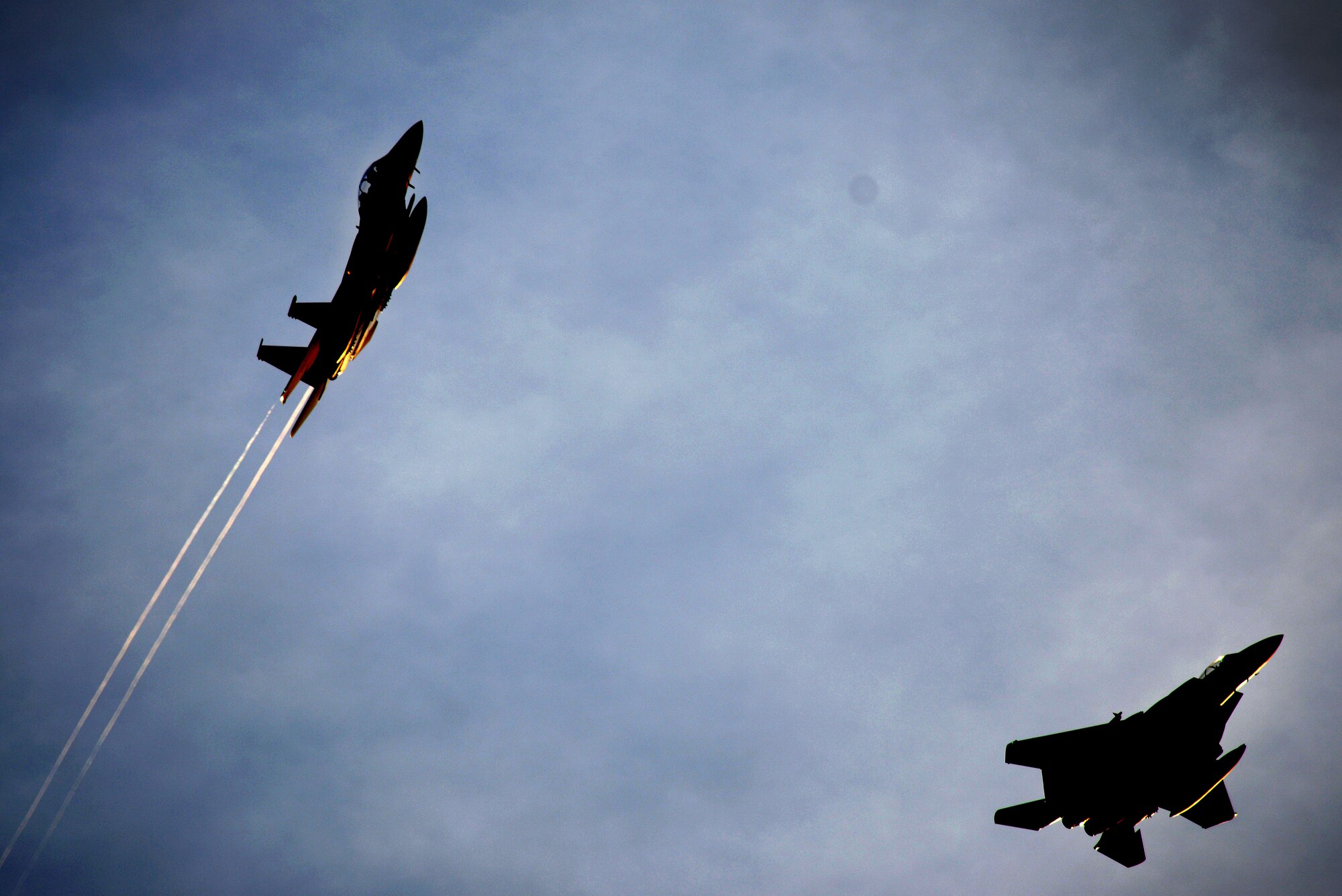 An F-15E Strike Eagle from the 492nd Fighter Squadron peels off from a formation April 20, at Royal Air Force Lakenheath, England. The F-15's conducted air-to-air fighter integration training with F-22 Raptors from the 95th Fighter Squadron which allows the legacy aircraft a unique opportunity to fly alongside the advanced fifth-generation aircraft while working with joint partners and NATO allies. (U.S. Air Force photo/ Tech. Sgt. Matthew Plew)