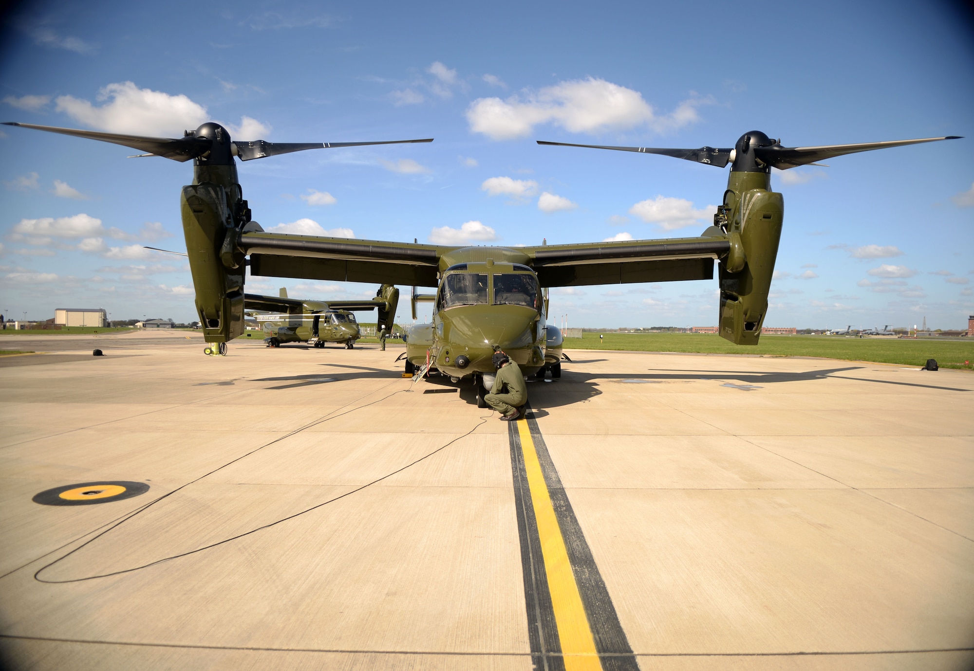 U.S. Marine Corps Staff Sgt. Patrick Riley and Cpl. Jonathan Renshaw, MV-22 Osprey crew chiefs, conduct pre-flight inspections to ensure the aircraft are flight ready April 19, 2016, on RAF Mildenhall, England. The aircraft were on the flightline in support of the President’s visit to the United Kingdom and Germany where he held bilateral meetings and participated in the Hannover Messe. U.S. European Command and U.S. Air Forces in Europe-Air Forces Africa were working with other government agencies and authorities in the U.K. and Germany to provide assistance as requested to ensure a successful visit. (U.S. Air Force photo by Airman 1st Class Tenley Long/Released)