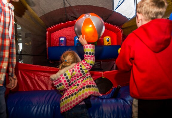 Keira Dell, child of U.S. Air Force Staff Sgt. Brady Dell, a 52nd Component Maintenance Squadron jet engine intermediate maintenance crew supervisor, tosses a beach ball in one of the stands during the Spring Fling event in the Base Exchange at Spangdahlem Air Base, Germany, April 15, 2016. The fair exposed families to the available resources and agencies available on base to aid special needs family members. (U.S. Air Force photo by Airman 1st Class Timothy Kim/Released)