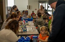 Spangdahlem community members participate in activities during the Spring Fling event in the Base Exchange at Spangdahlem Air Base, Germany, April 15, 2016. The fair held many activities such as an inflatable target range, face painting stations and other sensory-related booths. (U.S. Air Force photo by Airman 1st Class Timothy Kim/Released)