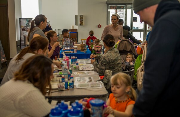 Spangdahlem community members participate in activities during the Spring Fling event in the Base Exchange at Spangdahlem Air Base, Germany, April 15, 2016. The fair held many activities such as an inflatable target range, face painting stations and other sensory-related booths. (U.S. Air Force photo by Airman 1st Class Timothy Kim/Released)