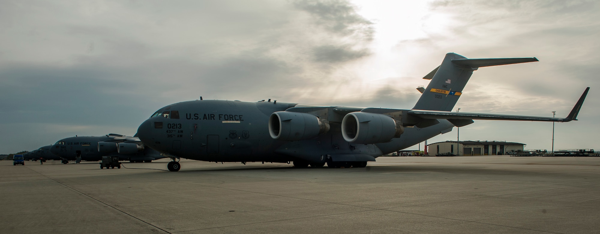 Seven Boeing C-17 Globermaster III aircrafts remain parked on the 726th Air Mobility Squadron passenger terminal flightline at Spangdahlem Air Base, Germany, April 22, 2016. The squadron enables the delivery of war-fighting and humanitarian equipments and supplies through rapid global air mobility, providing air transportation, cargo, maintenance and enroute support to Allied and American Forces. (U.S. Air Force photo by Airman 1st Class Timothy Kim/Released)