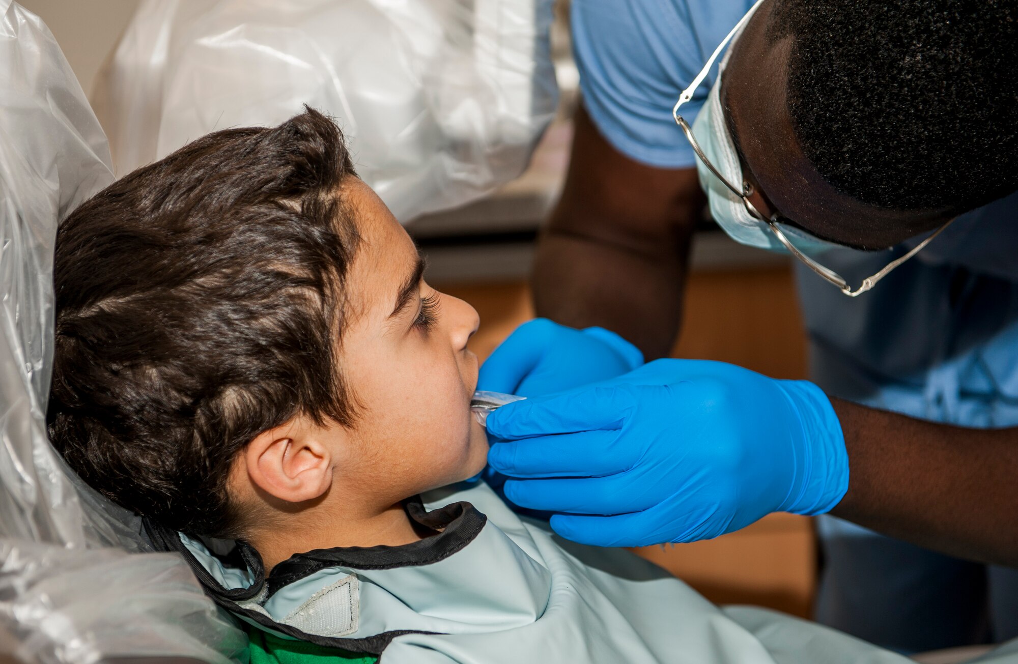 Ricardo Burgos-Mercado, son of U.S. Air Force Staff Sgt. Fernando Burgoz-Ortiz, Armed Forces Network operations manager, prepares to have an X-Ray taken of his teeth during the 52nd Dental Squadron’s semi-annual children’s walk-in at Spangdahlem Air Base, Germany, April 22, 2016. Aside from check-ups, dentists educate parents and children on proper oral hygiene to fight cavities and gingivitis. (U.S. Air Force photo by Airman 1st Class Timothy Kim/Released)
